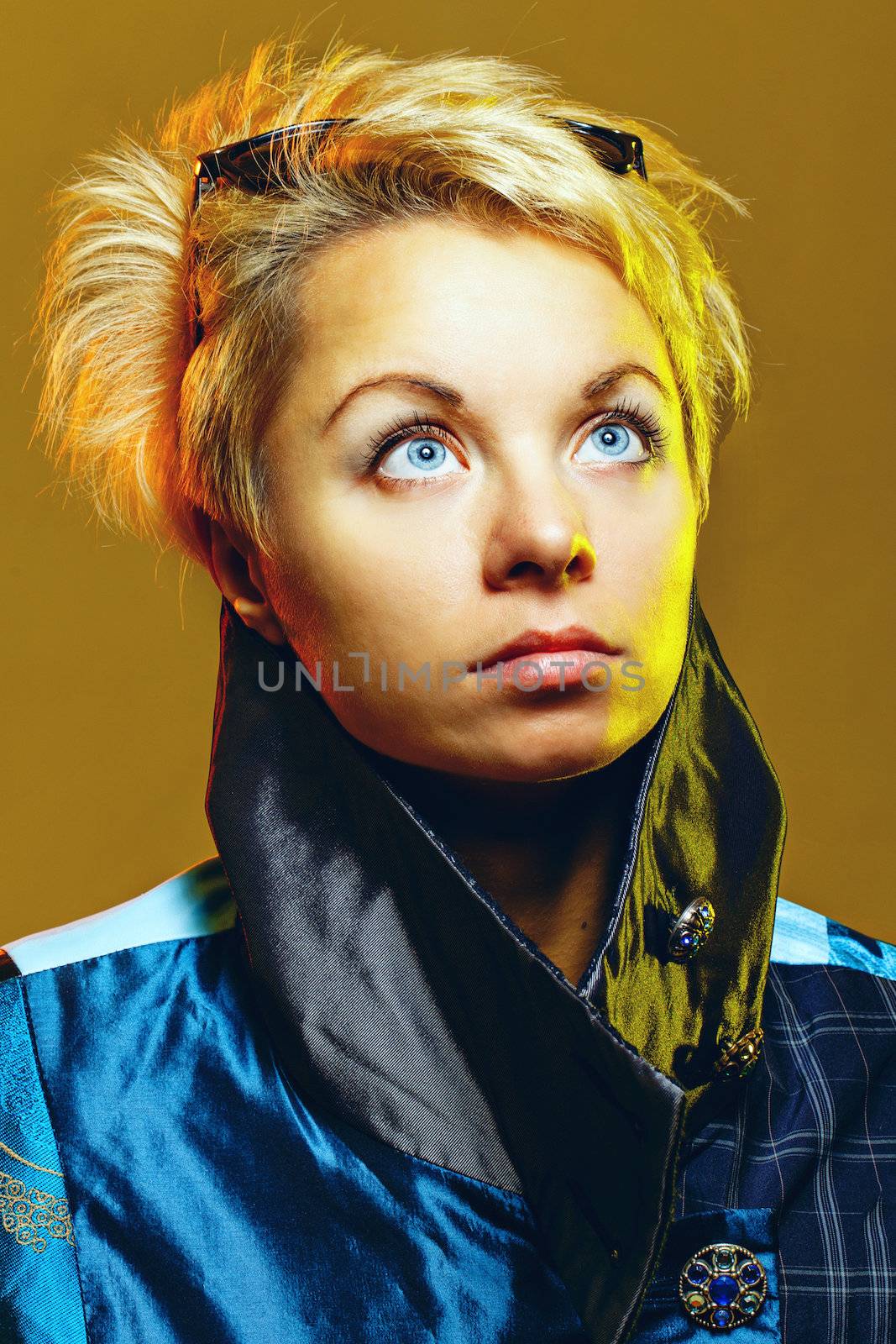 Portrait of a girl in a jacket with sunglasses on her head