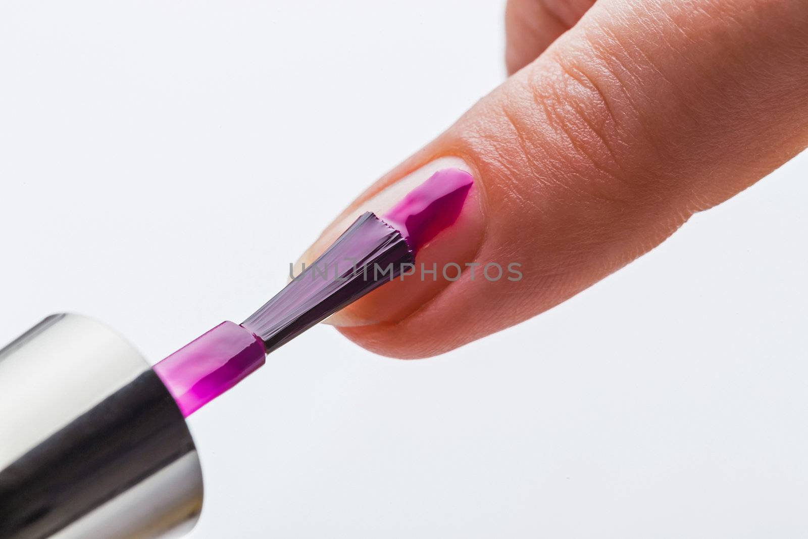 Painting female fingernails with nail polish by oleg_zhukov