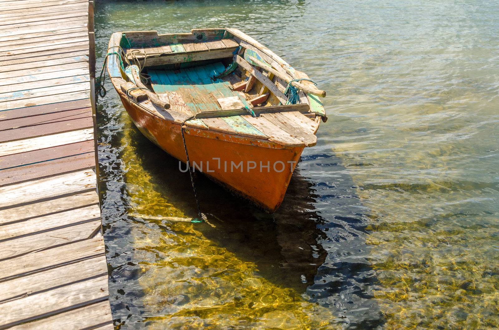 Old orange boat by a pier in San Andres y Providencia, Colombia