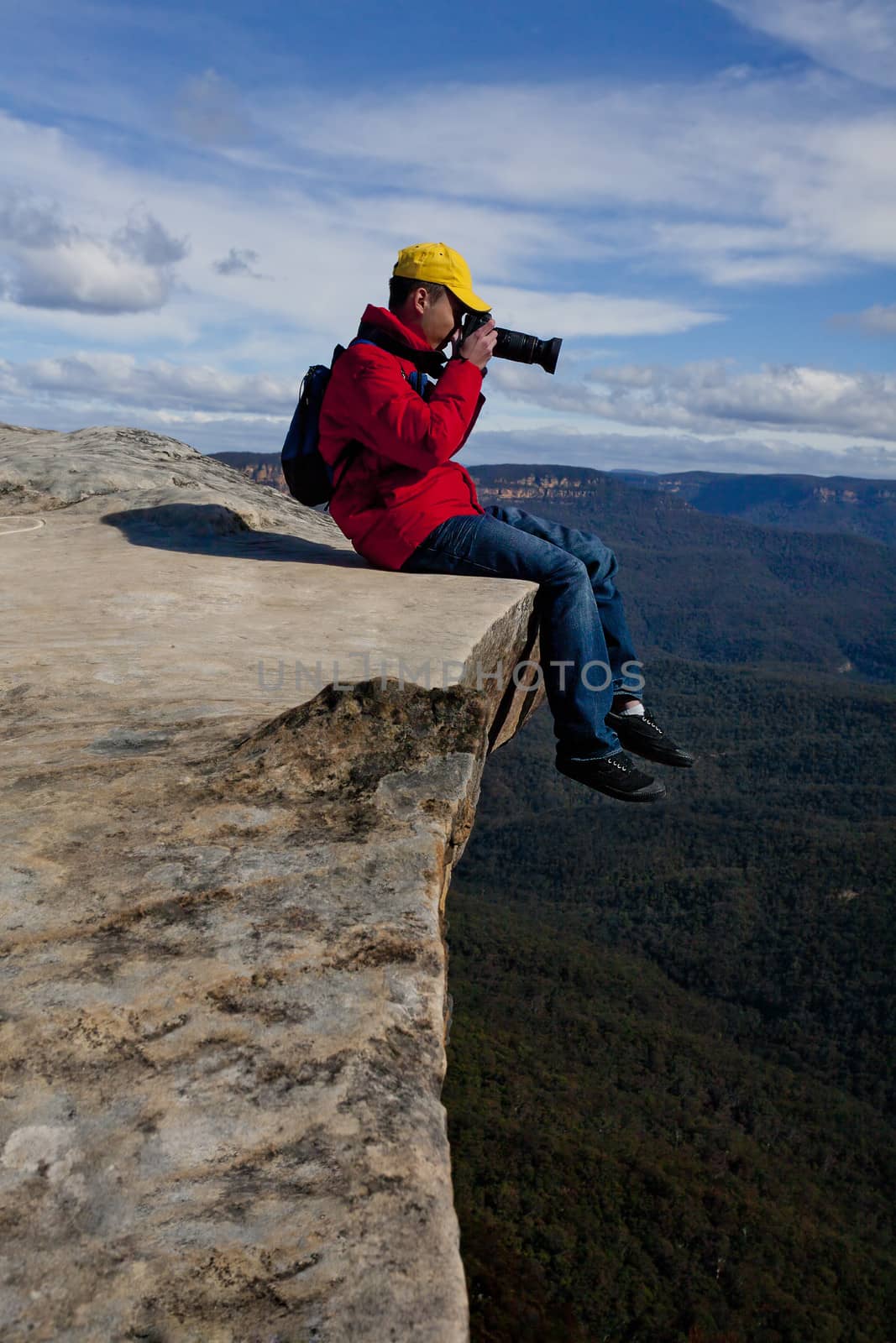 Tourist or photographer taking phots mountain landscape by lovleah