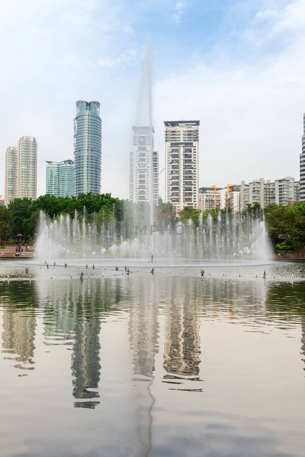 Fountain in modern city skyline with skyscraper on background