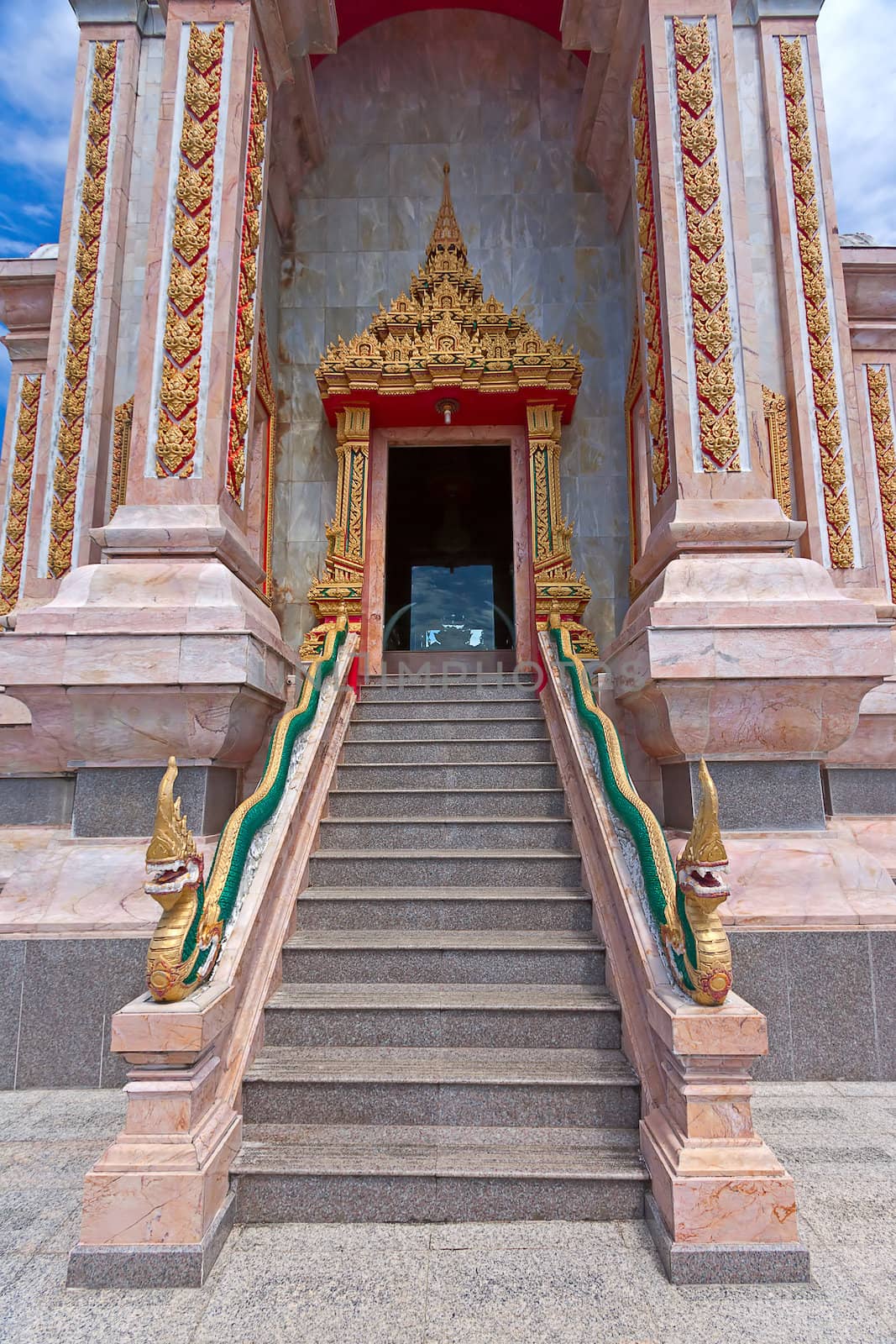 Granite staircase and entrance to  Buddhist temple, Thailand.