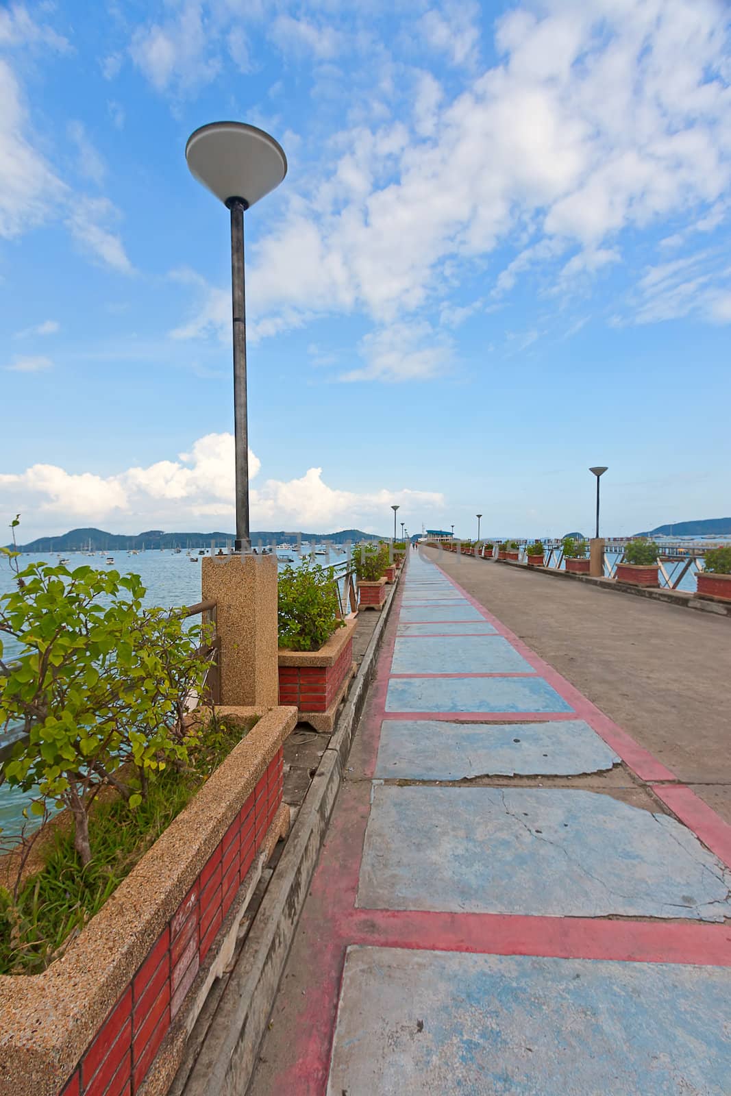 Berth with flower beds and lanterns on background blue sky, Thailand.