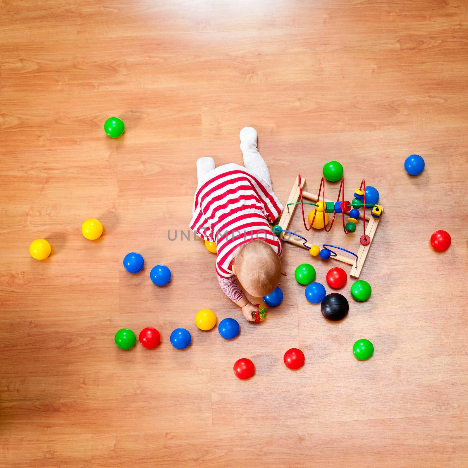 Top view of little girl playing on the floor