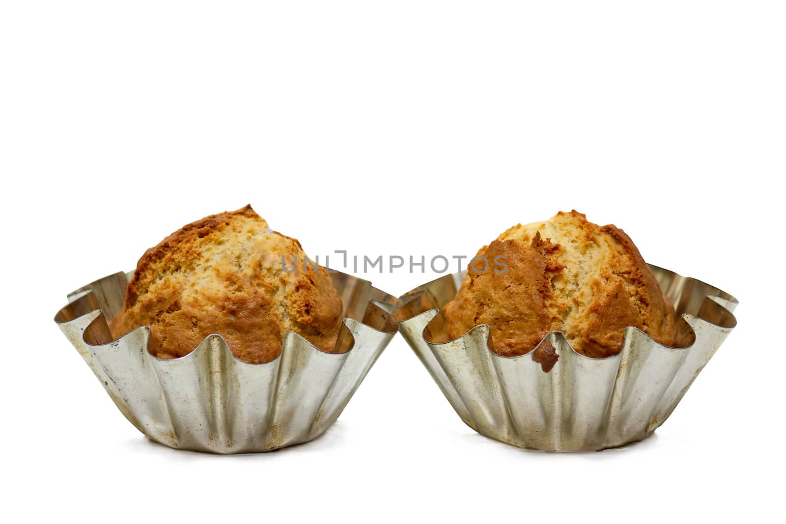 Cupcakes in forms, isolated on white background.