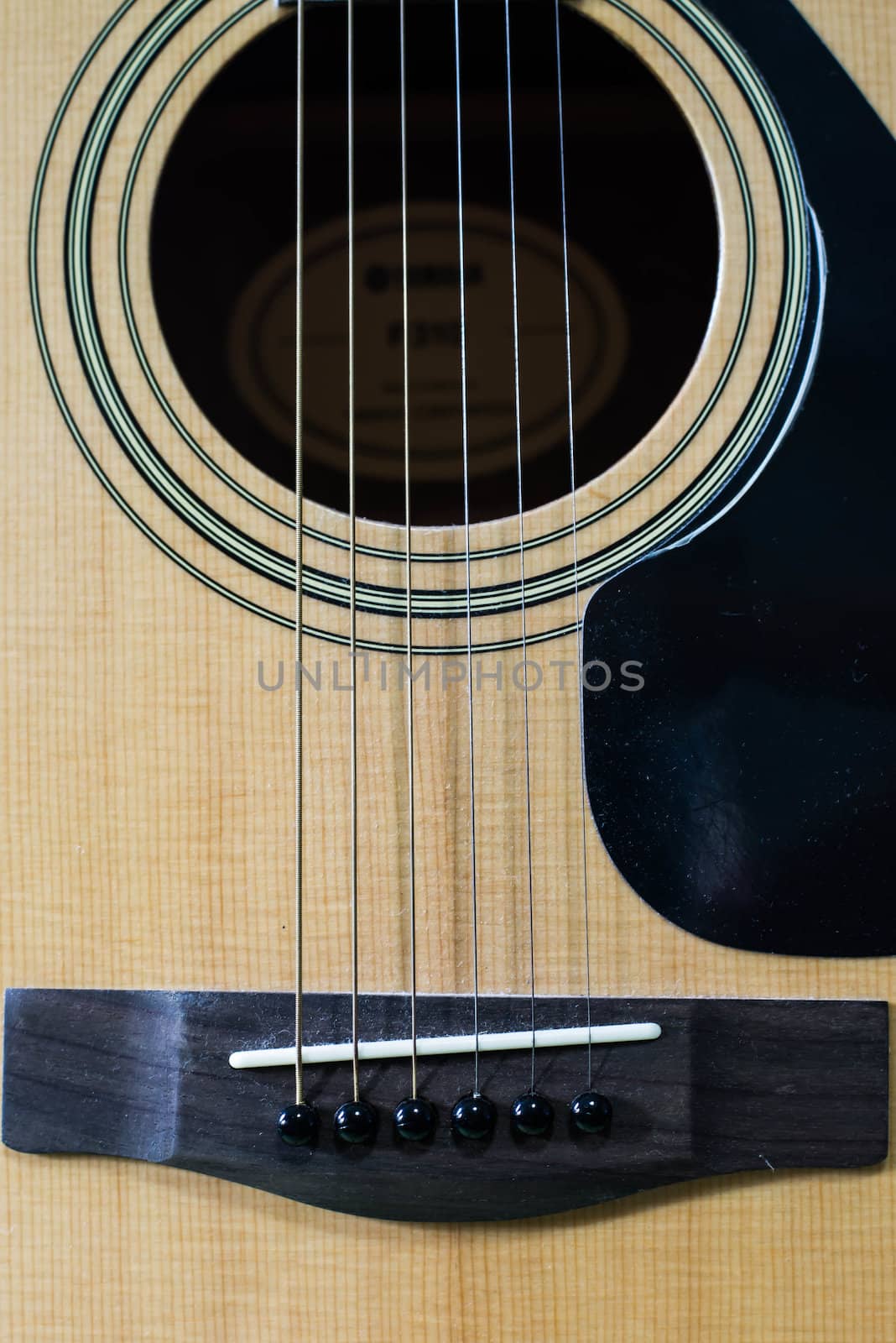 Acoustic brown guitar.Zoom in the acoustic guitar strings.
