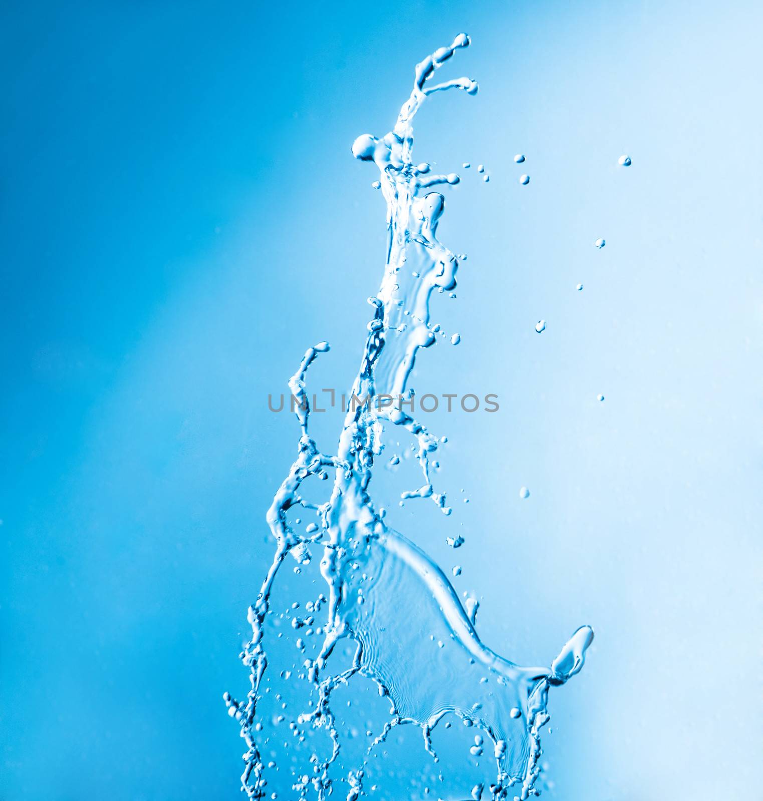 shot of water splashing on blue background