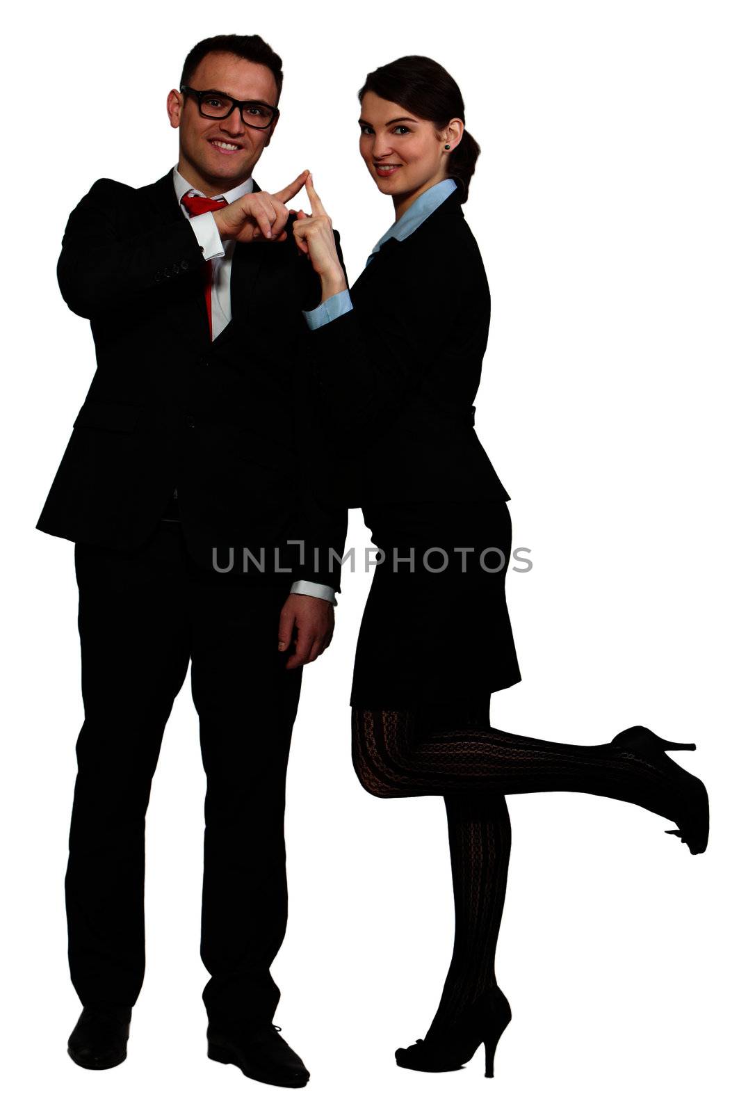 Young business couple touching their index fingers while posing against a white background.