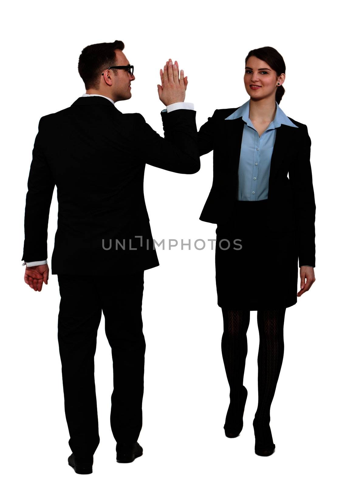 Young business couple celebrating their success giving each other a high five, against a white background.