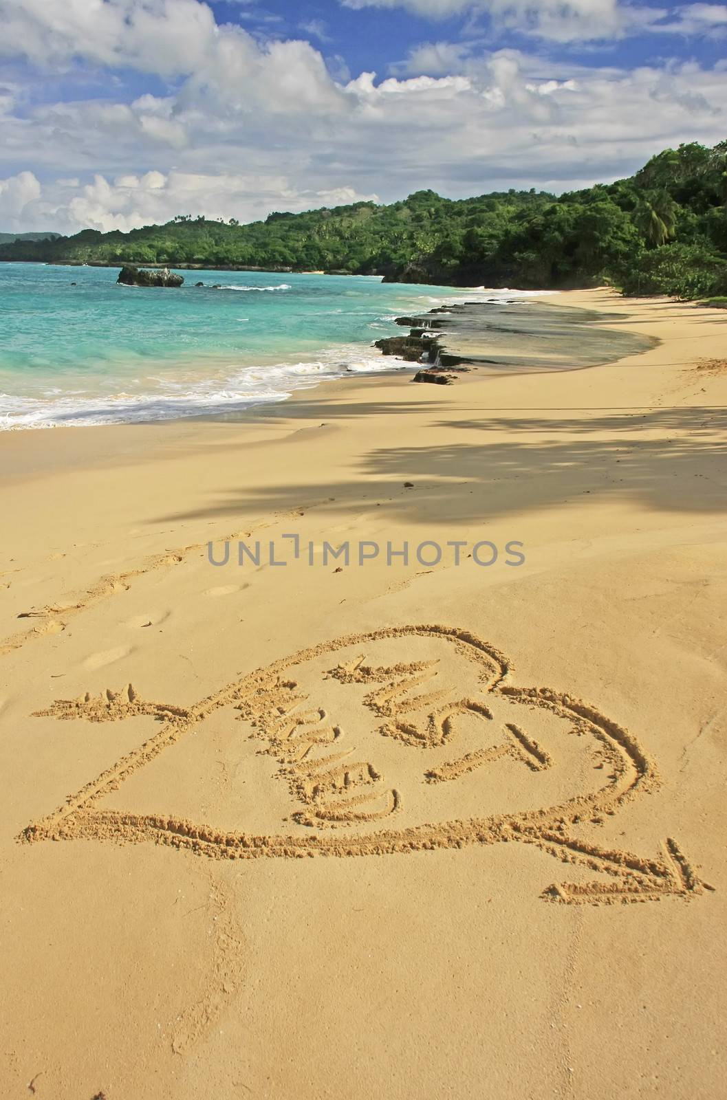 "Just married" written in sand on a beach