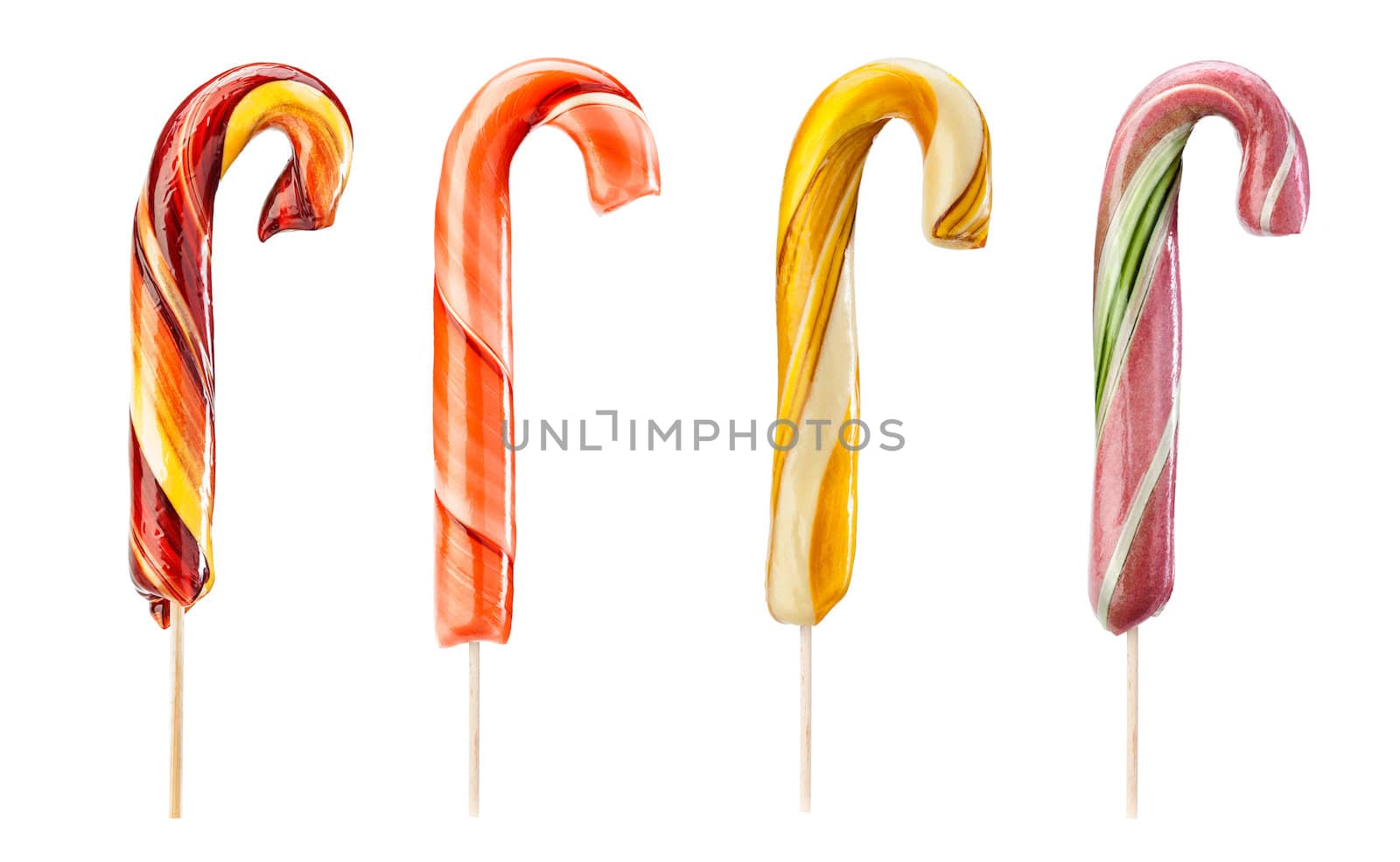 Set of twirled caramel candies on sticks, different colors. File includes clipping path