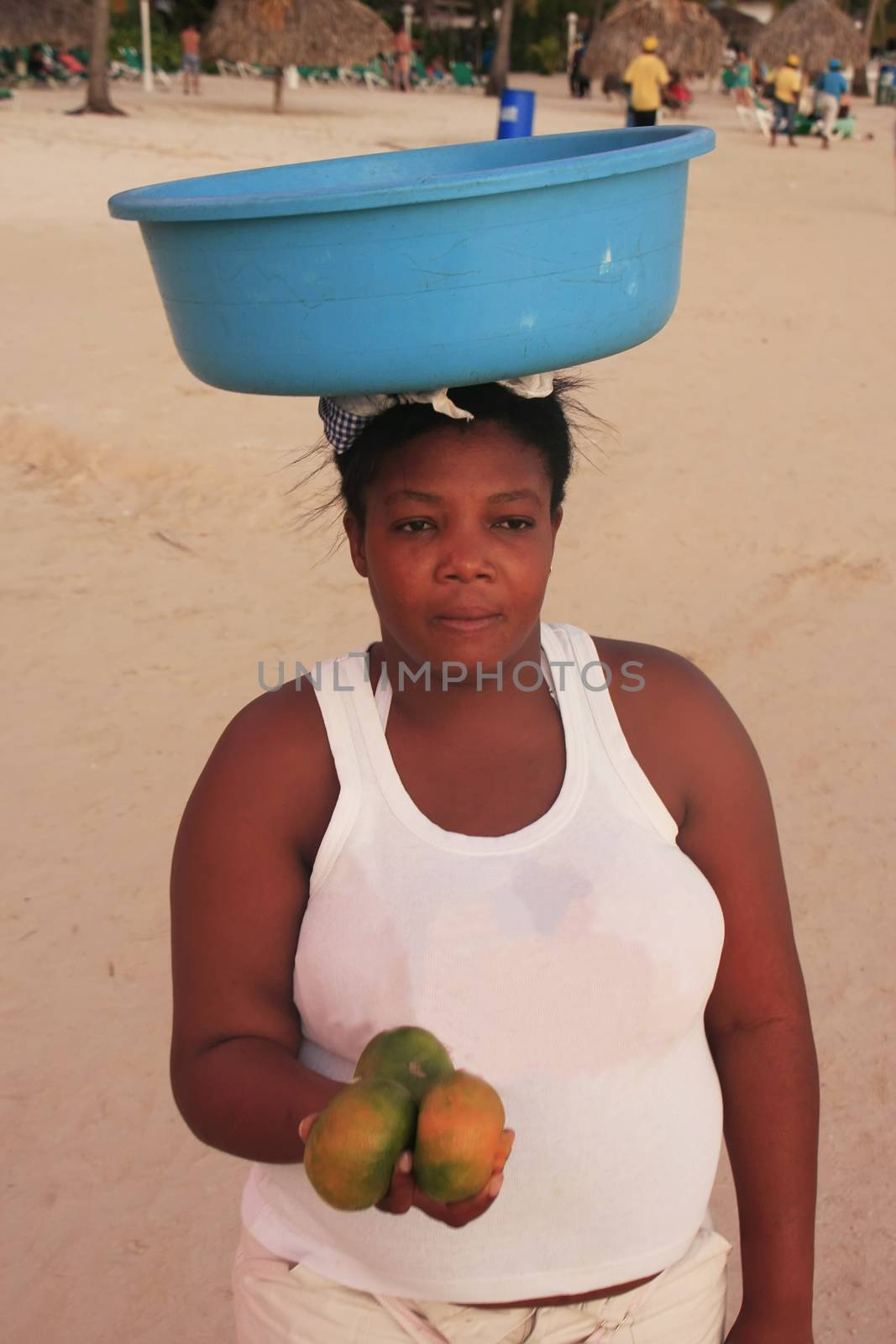 Local woman selling fruits at Boca Chica beach by donya_nedomam