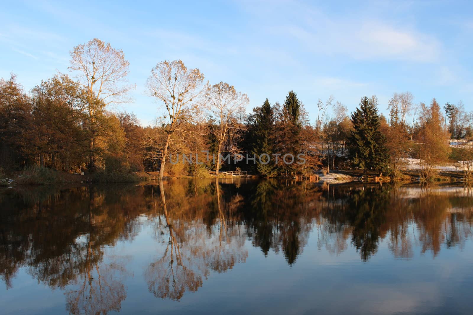 Beautiful lake in autumn with trees reflection.