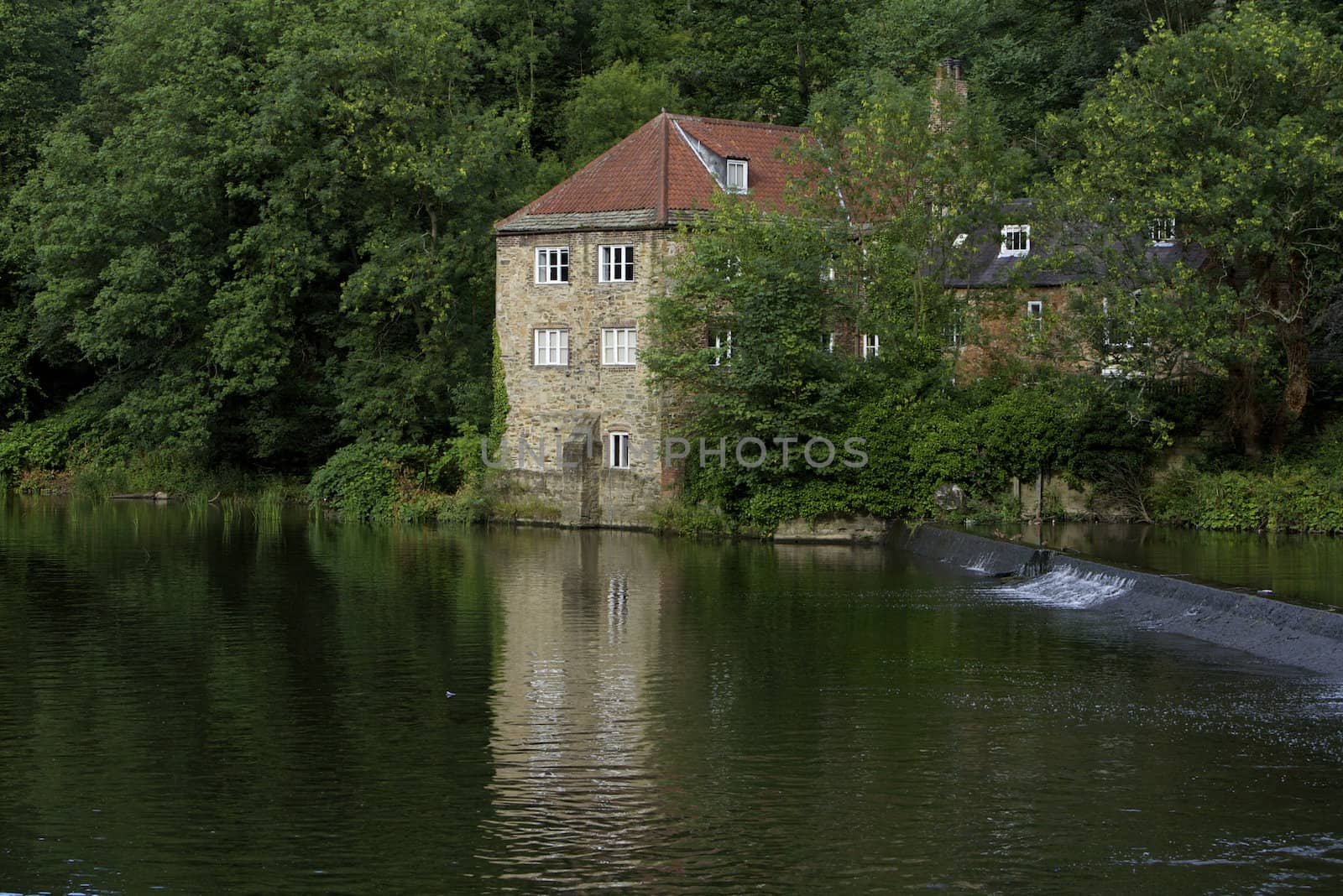 Historic old pump house on river banks in England