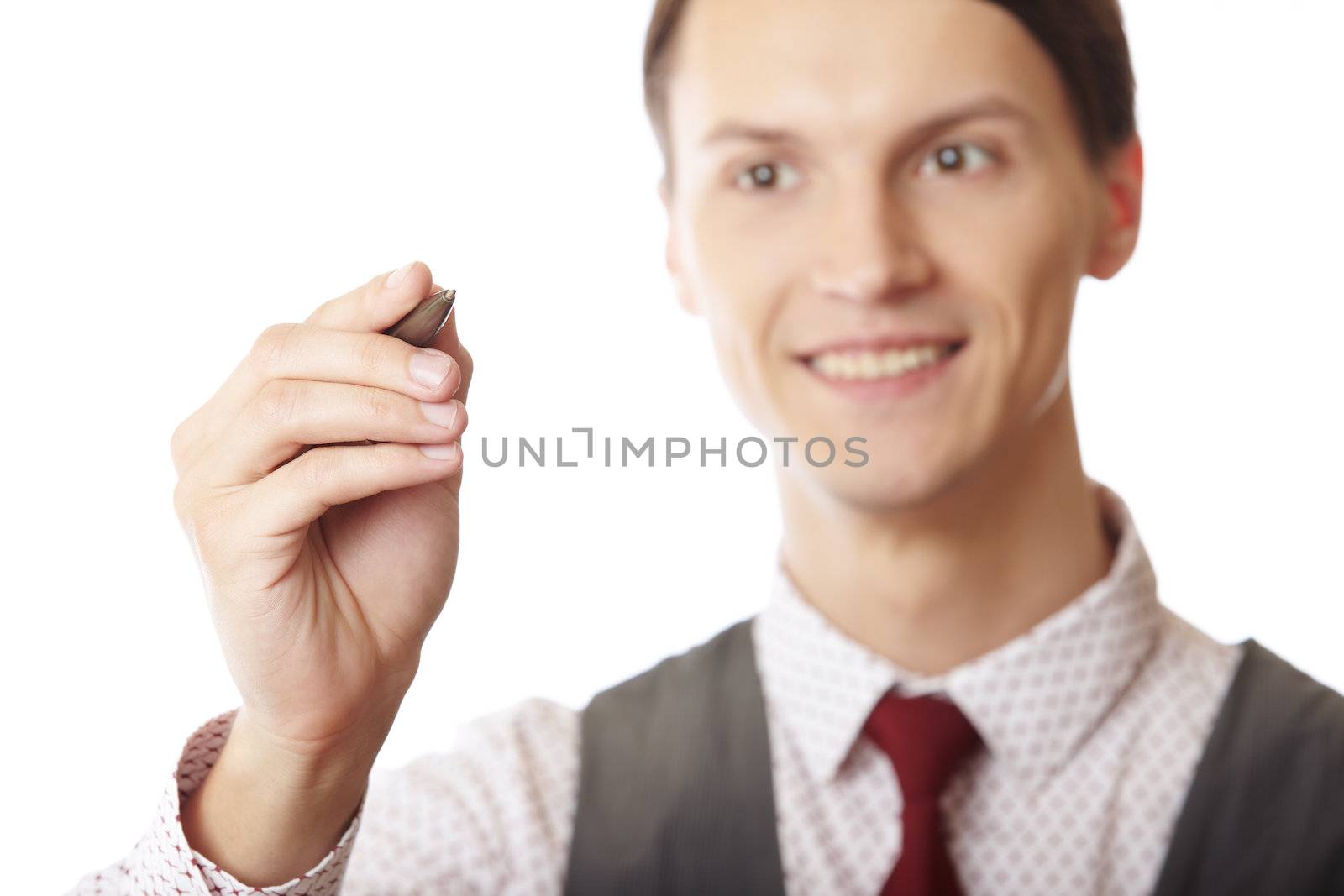 Smiling businessman is writing on a virtual whiteboard. Focus is on the hand and pen