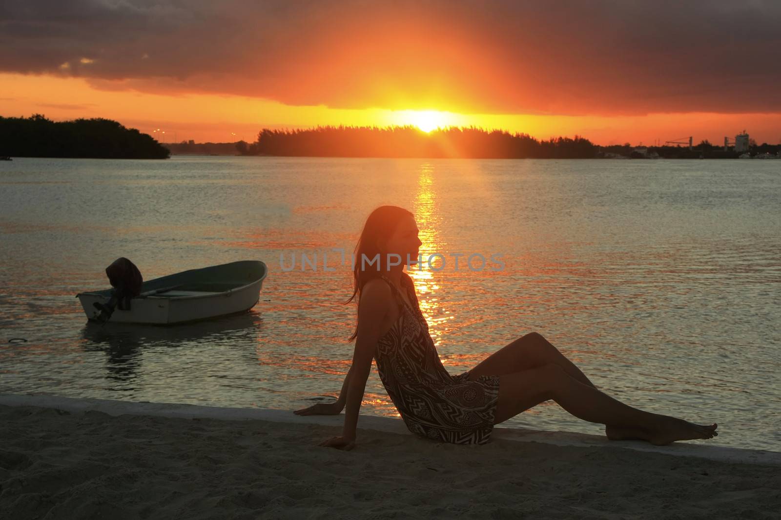 Silhouette of young woman at sunset, Boca Chica bay, Dominican Republic