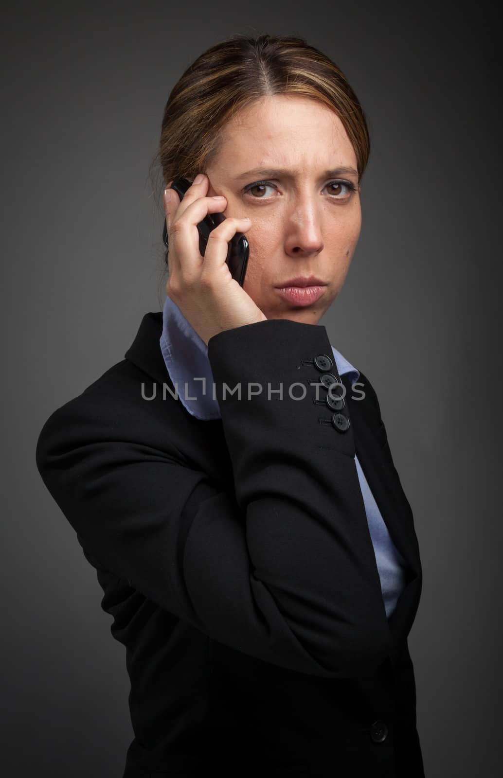 Attractive caucasion business woman in her 30s shot in studio isolated on a white background in her 30s shot in studio isolated on a grey background