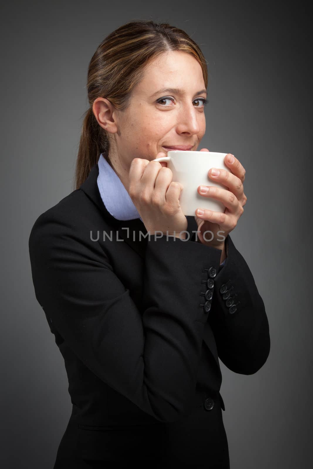 Attractive caucasion business woman in her 30s shot in studio isolated on a white background in her 30s shot in studio isolated on a grey background