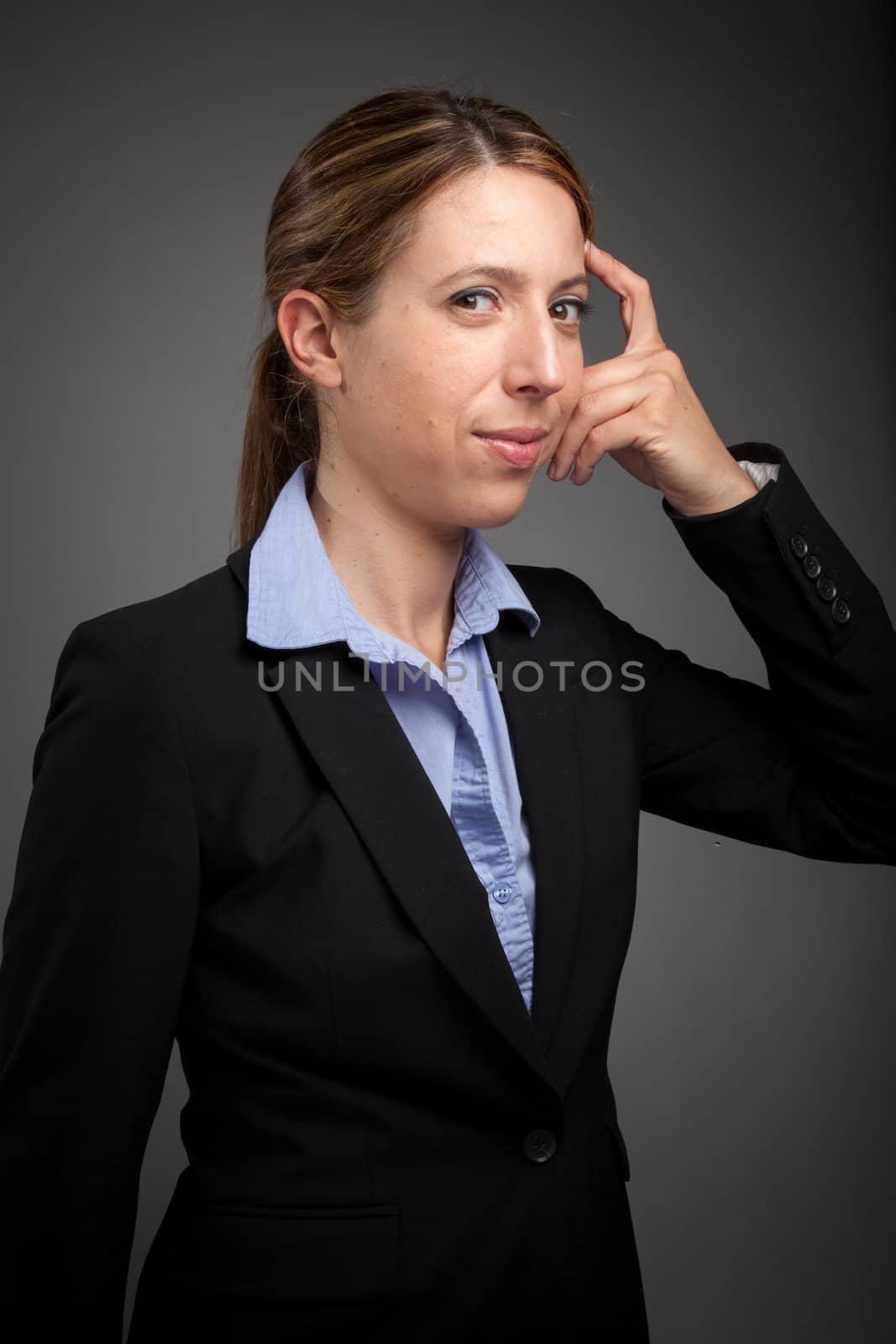 Attractive caucasion business woman in her 30s shot in studio isolated on a white background in her 30s shot in studio isolated on a grey background