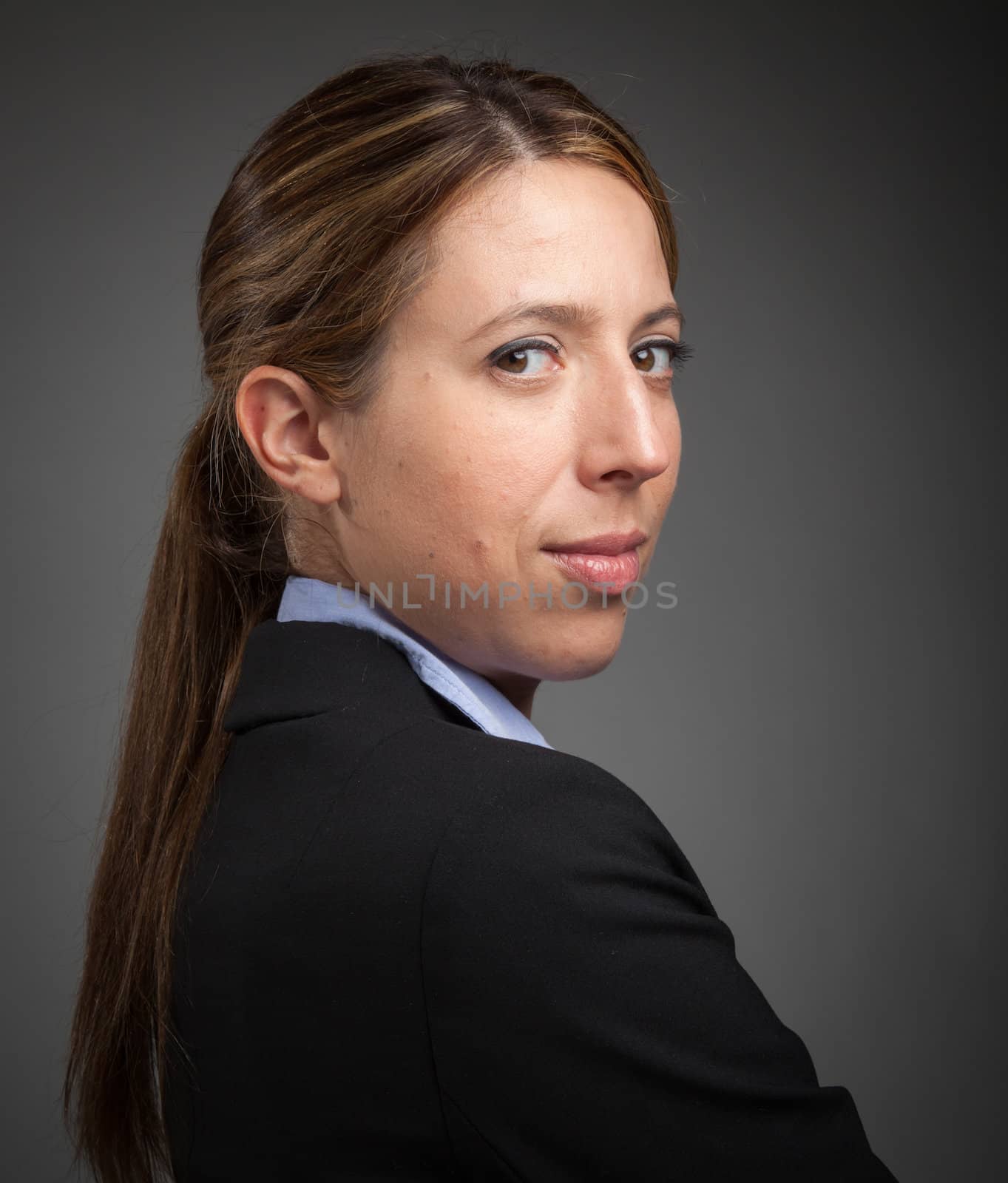 Attractive caucasion business woman in her 30s shot in studio isolated on a white background in her 30s shot in studio isolated on a grey background