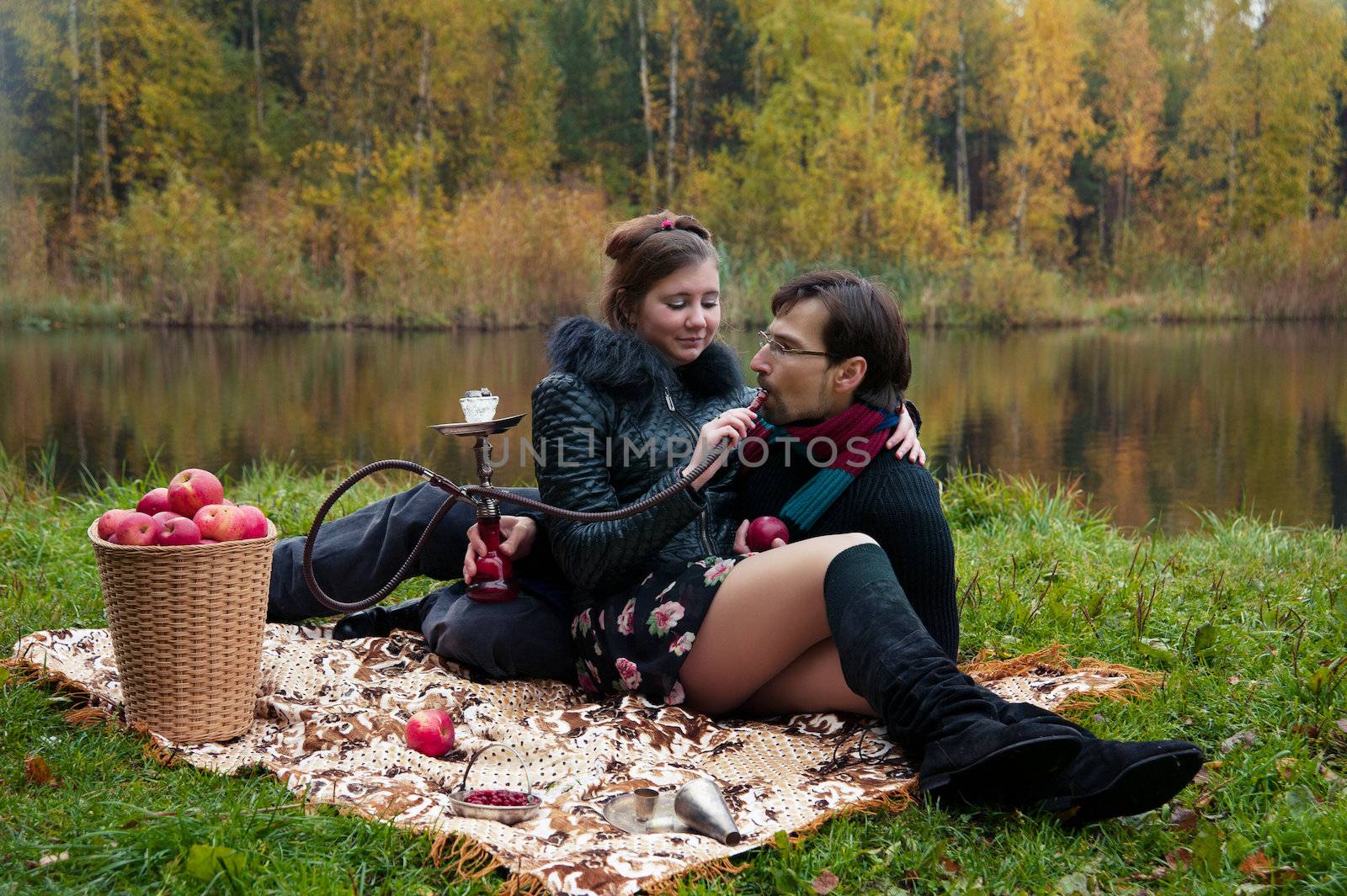 relationship between man and a woman at a picnic with a hookah