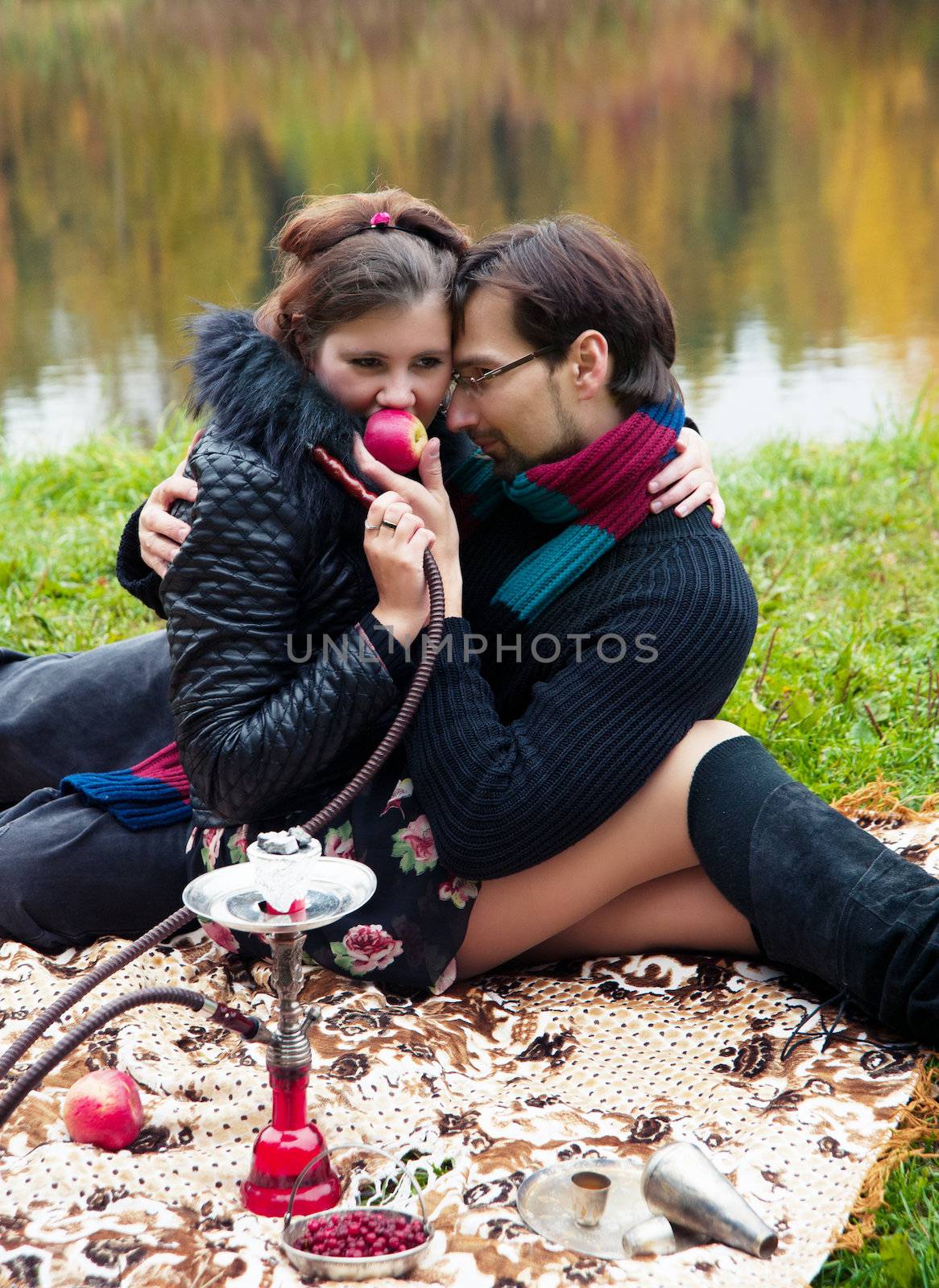relationship between man and a woman at a picnic with a hookah