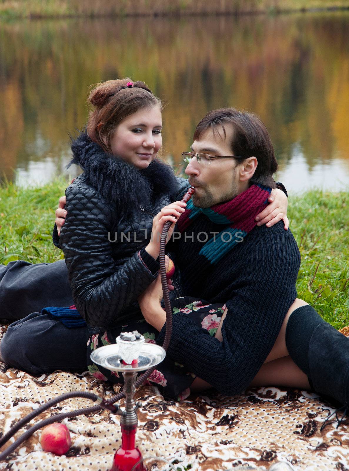 relationship between man and a woman at a picnic with a hookah