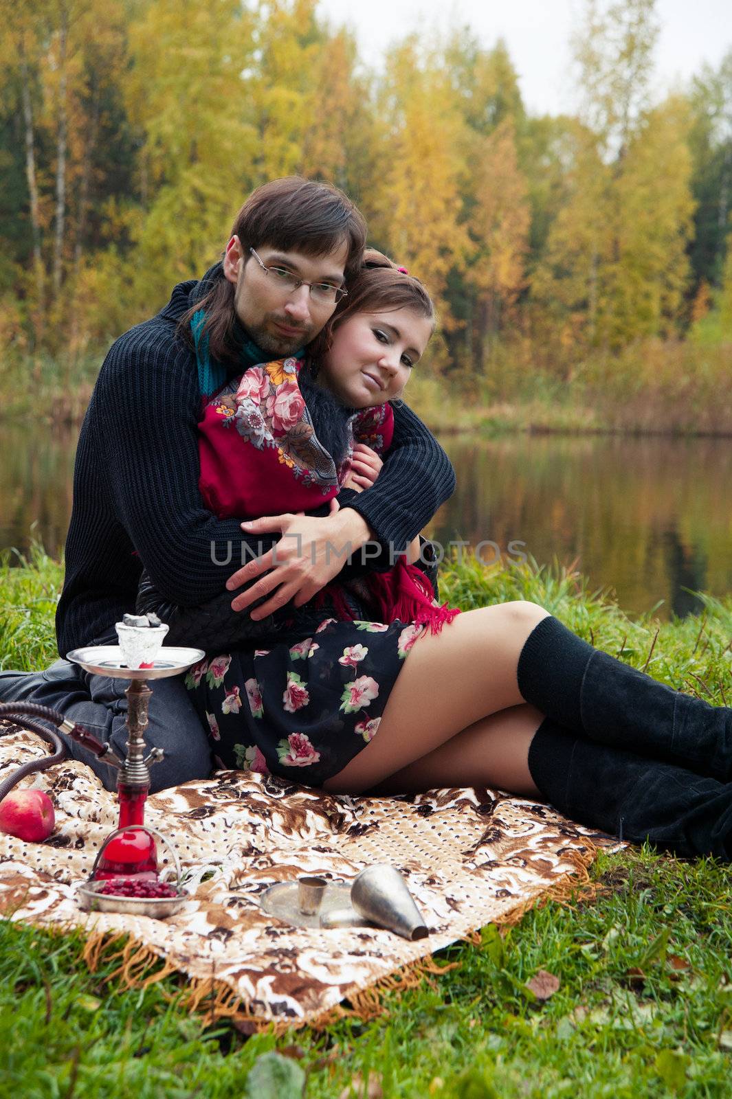 relationship between man and a woman at a picnic with a hookah