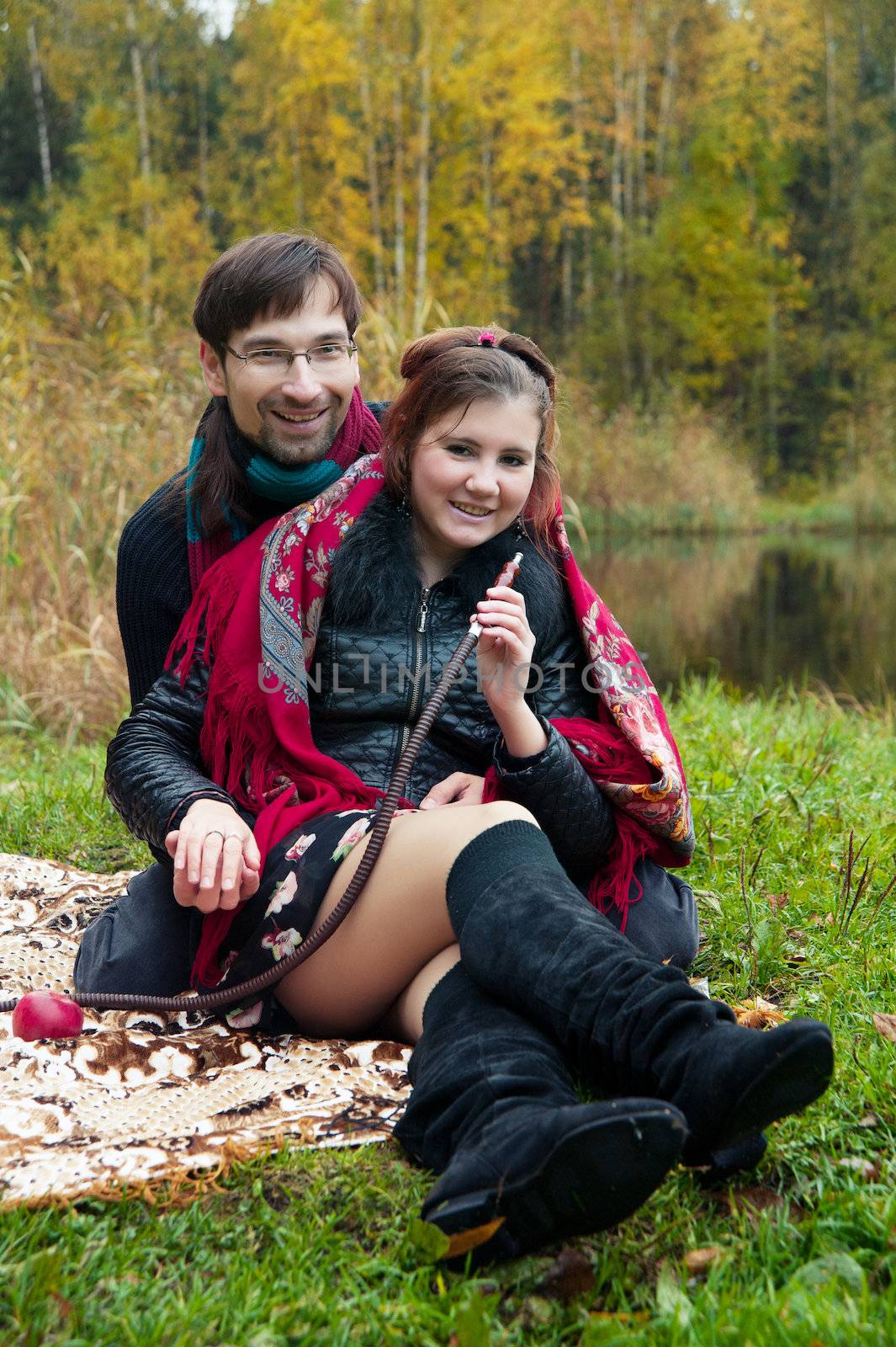 relationship between man and a woman at a picnic with a hookah