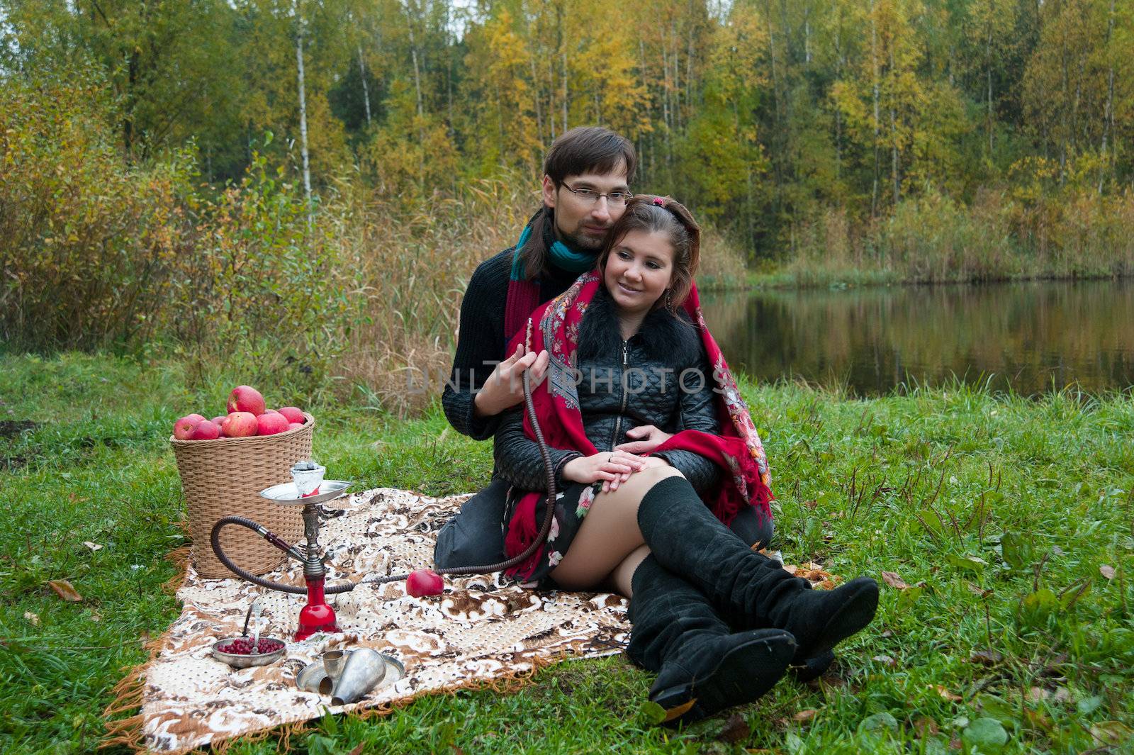 relationship between man and a woman at a picnic with a hookah