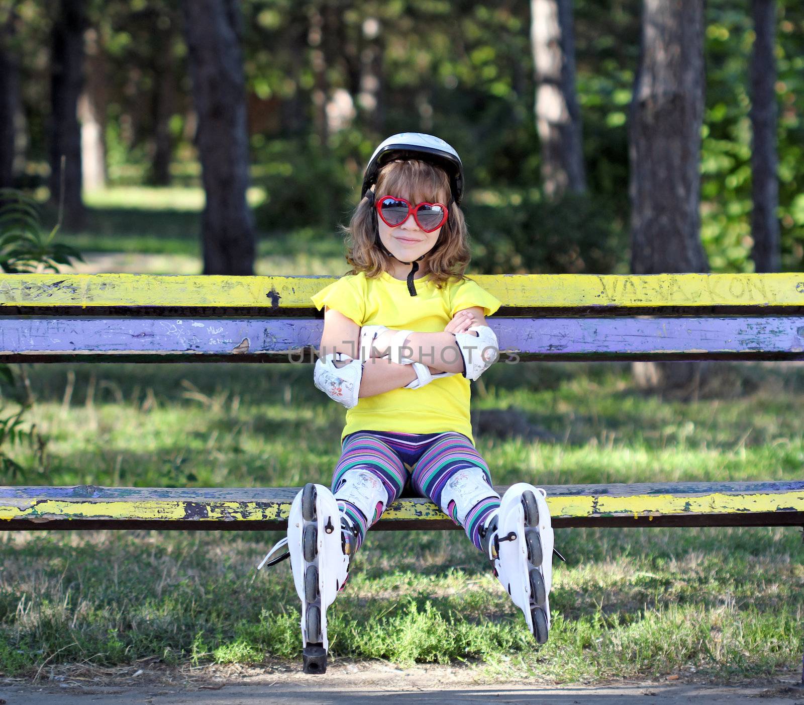 little girl with helmet and roller skates