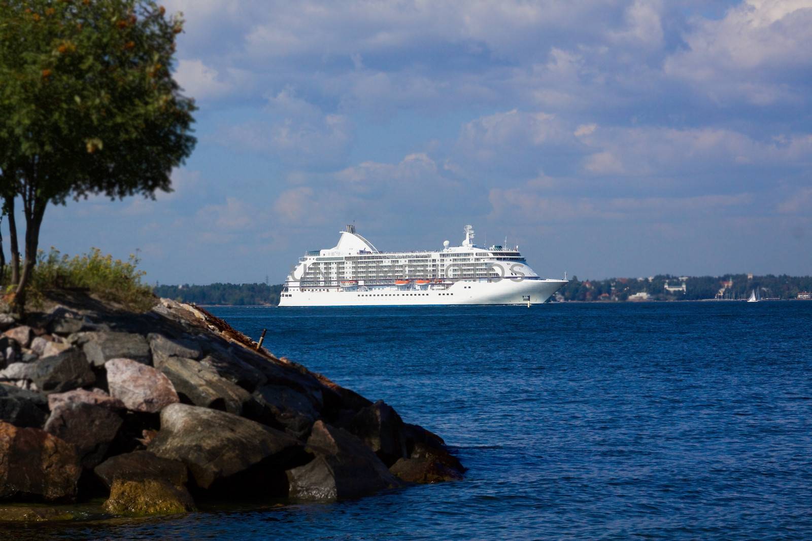 
the passenger cruise liner floats by sea by the island

