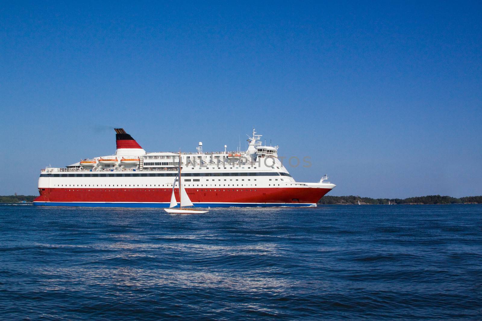 
the passenger cruise liner floats by sea by the island

