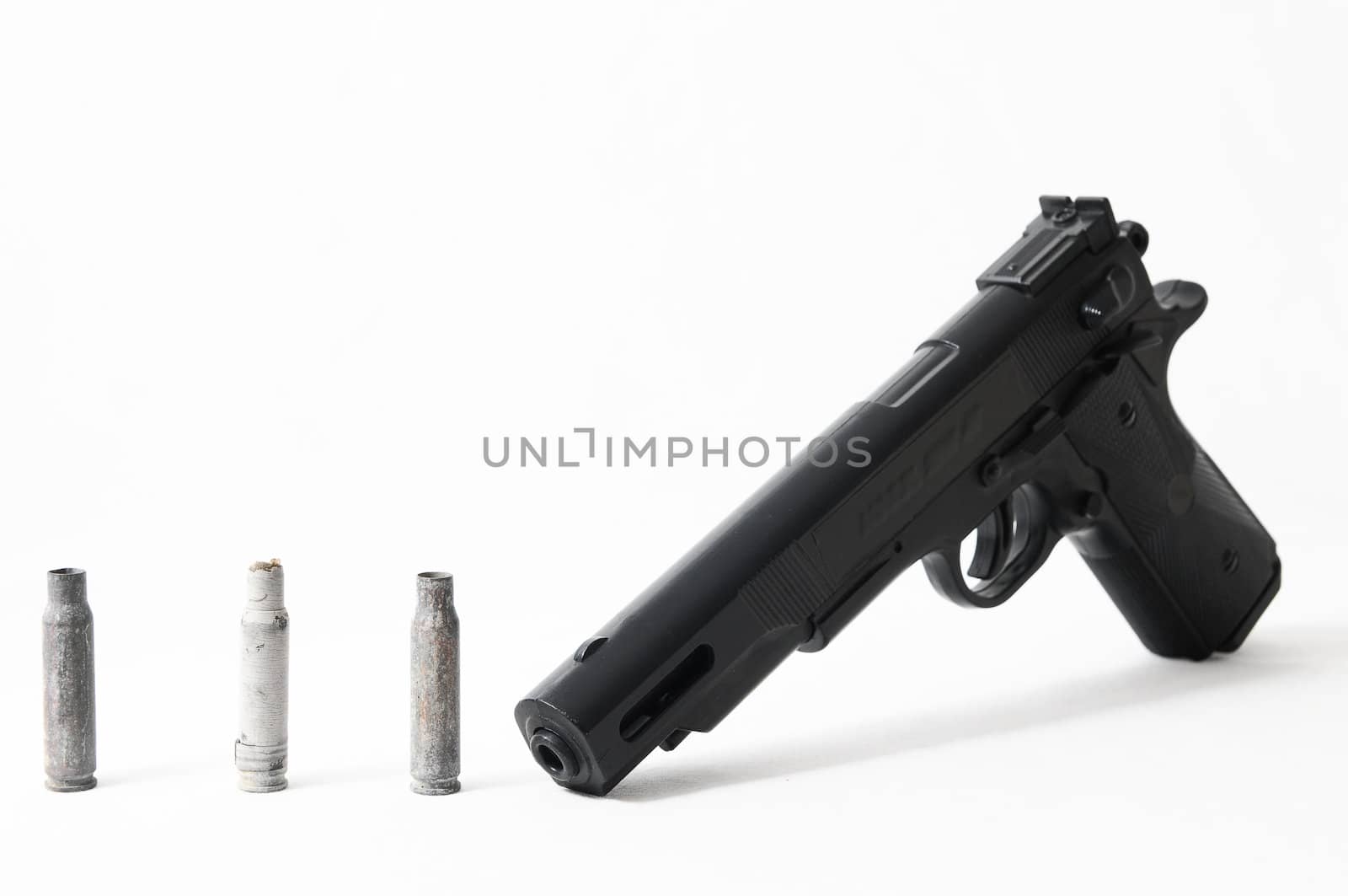 Pistol Gun and Bullets on a White Background