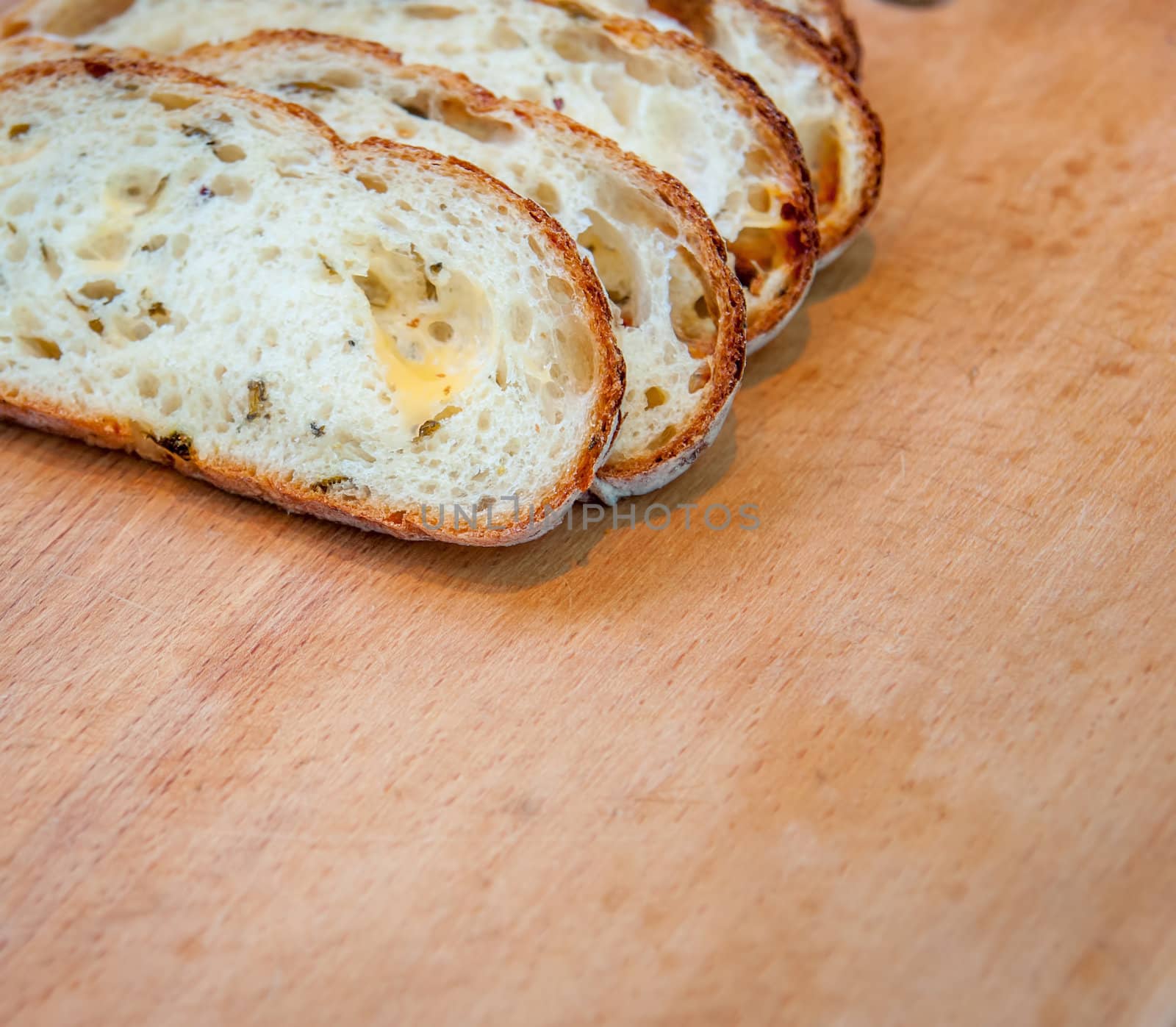 Closeup of sliced bread on a chopping board by Zhukow