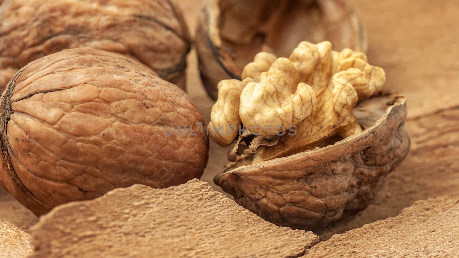 Walnuts on old wooden background,  paper texture by Zhukow