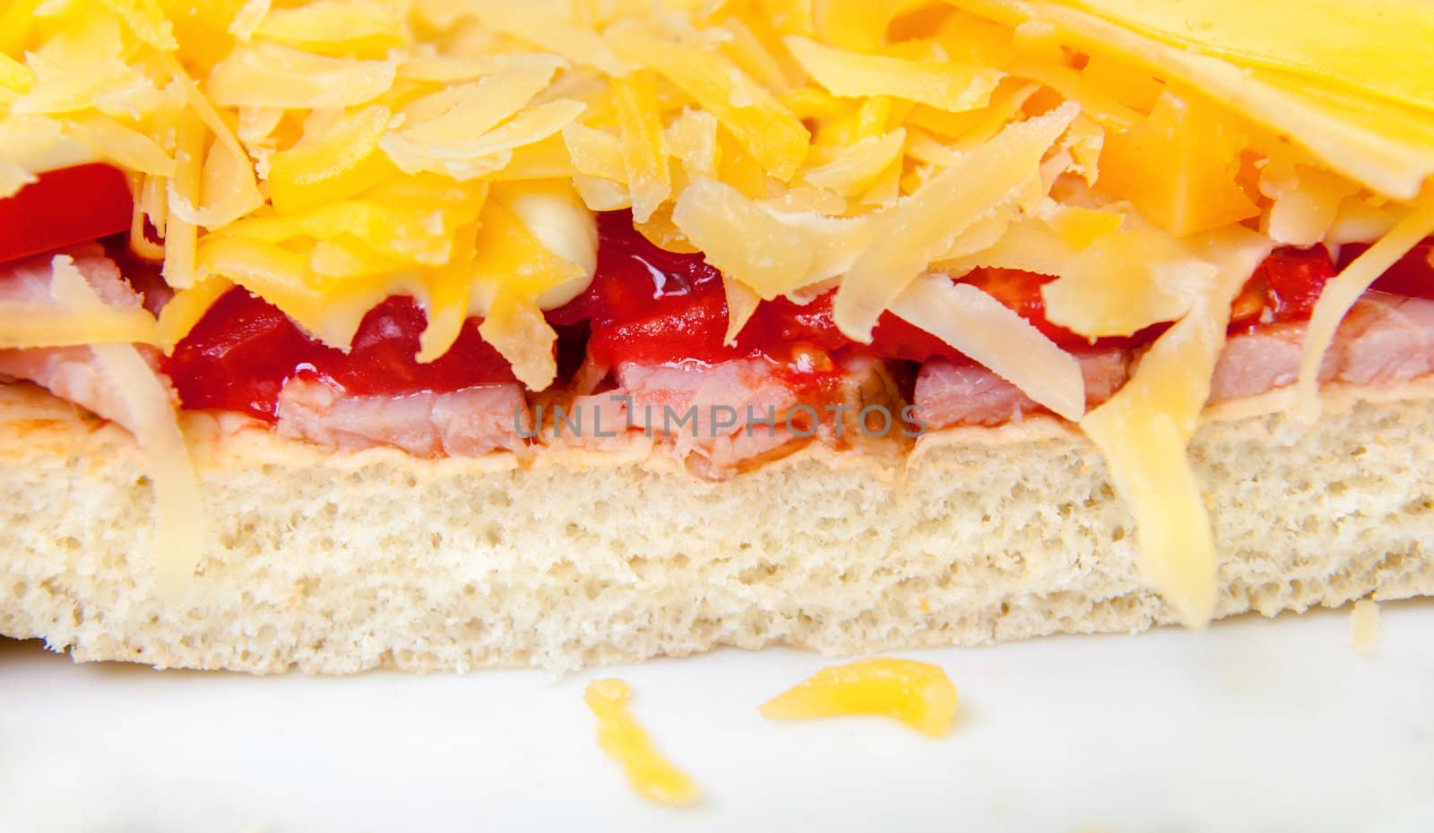 pizza with ham, cheese and tomato close up