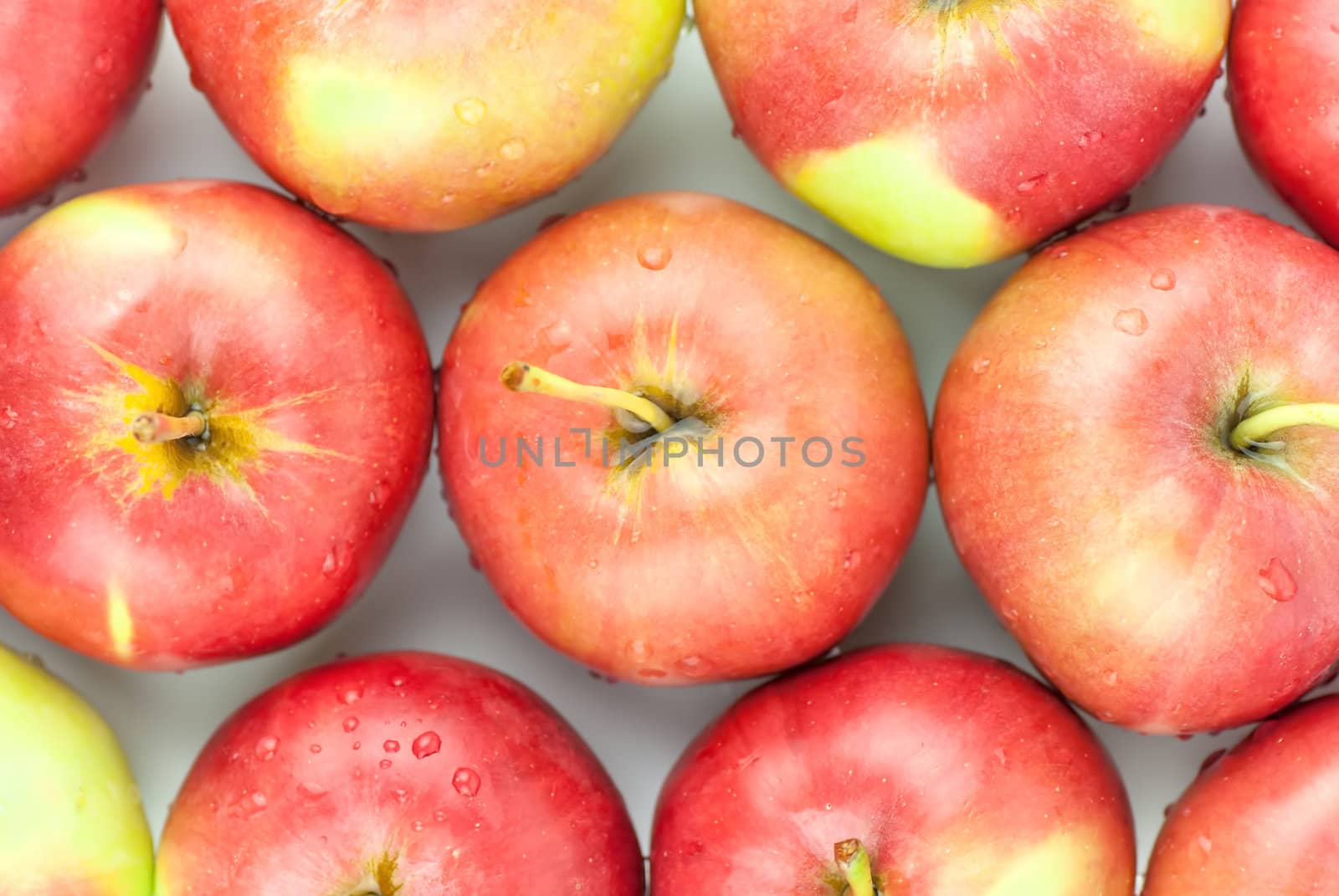 fresh red apples closeup by Zhukow