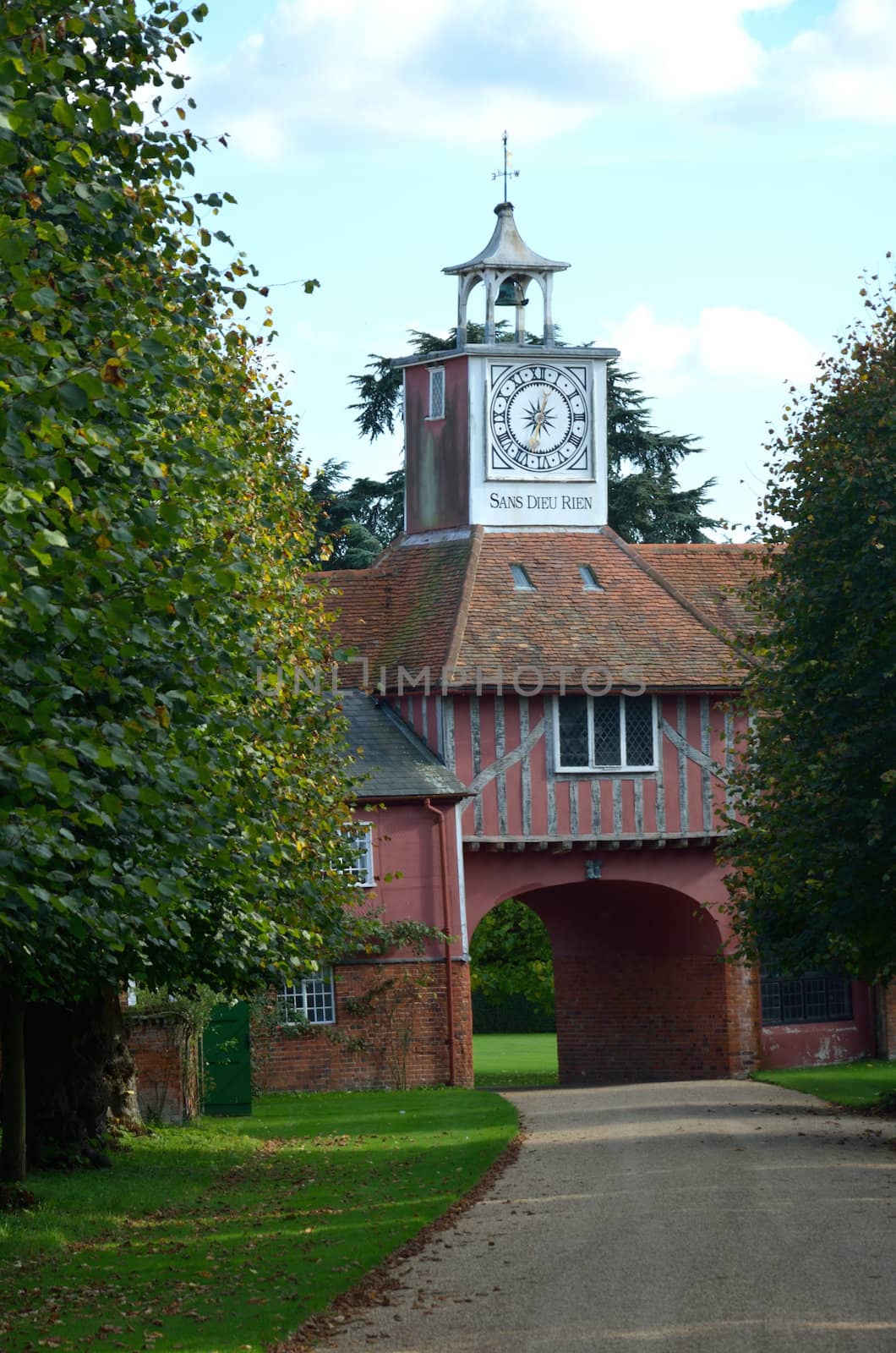 Gatehouse and clock through trees