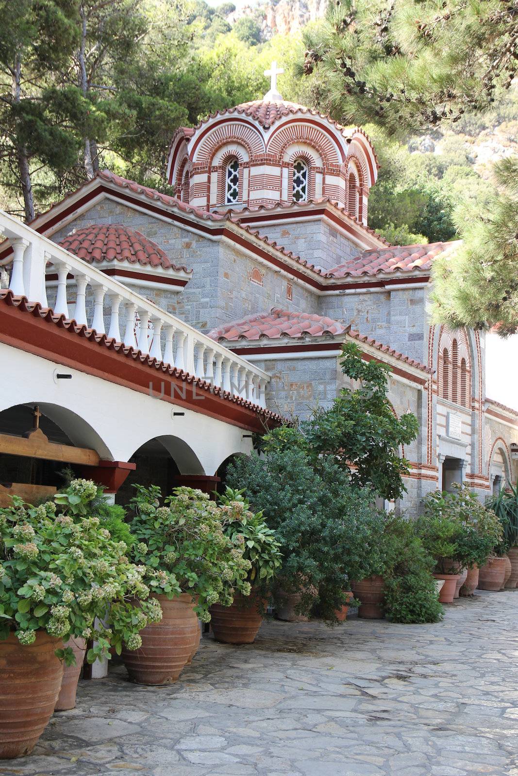 monastery courtyard surrounded by mountains and plants
