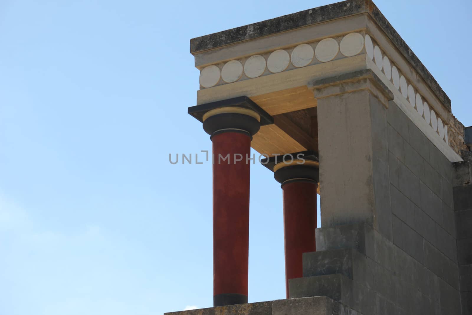 columns of an ancient palace on a background of blue sky