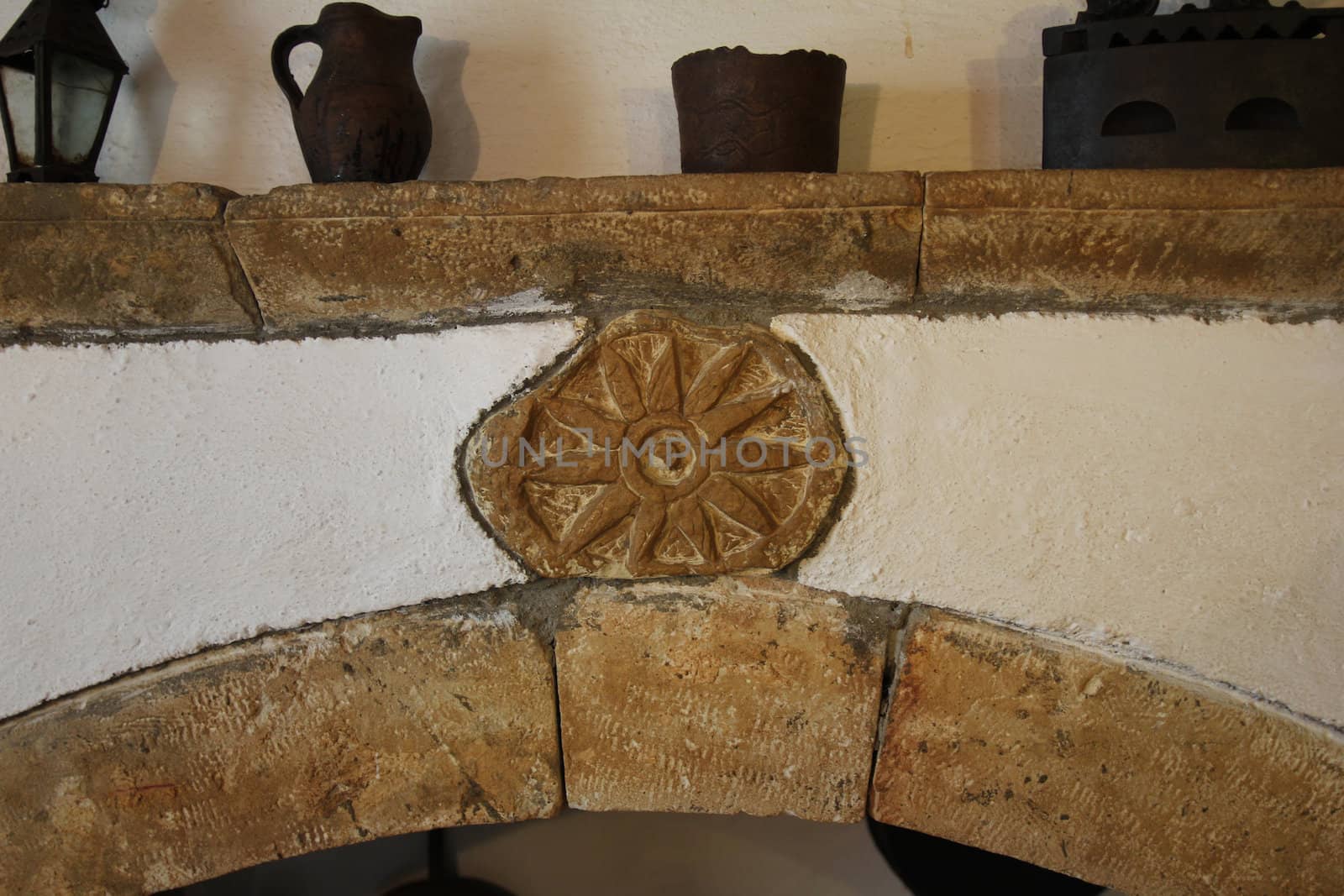 mantelpiece with antique dishes in a rustic house