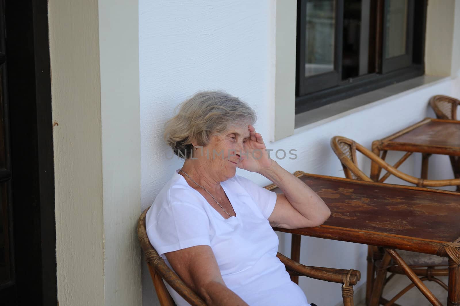 Smiling elderly woman sitting at the table