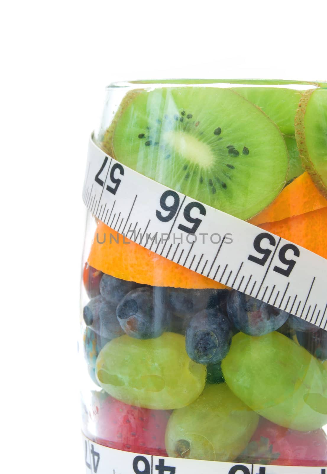 Five fruits packed into a glass including kiwi, berries and orange 