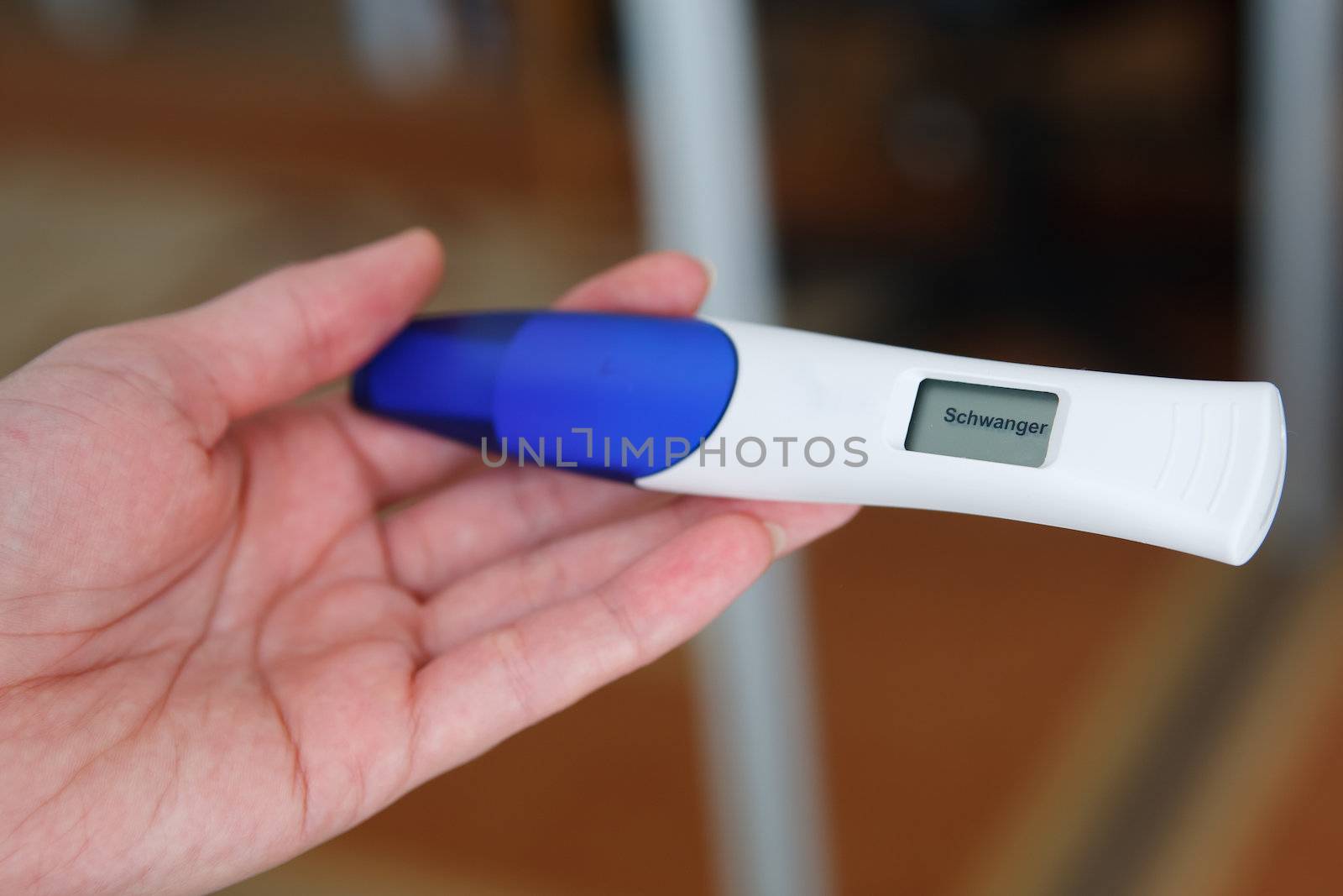 Woman taking a pregnancy test showing pregnant result