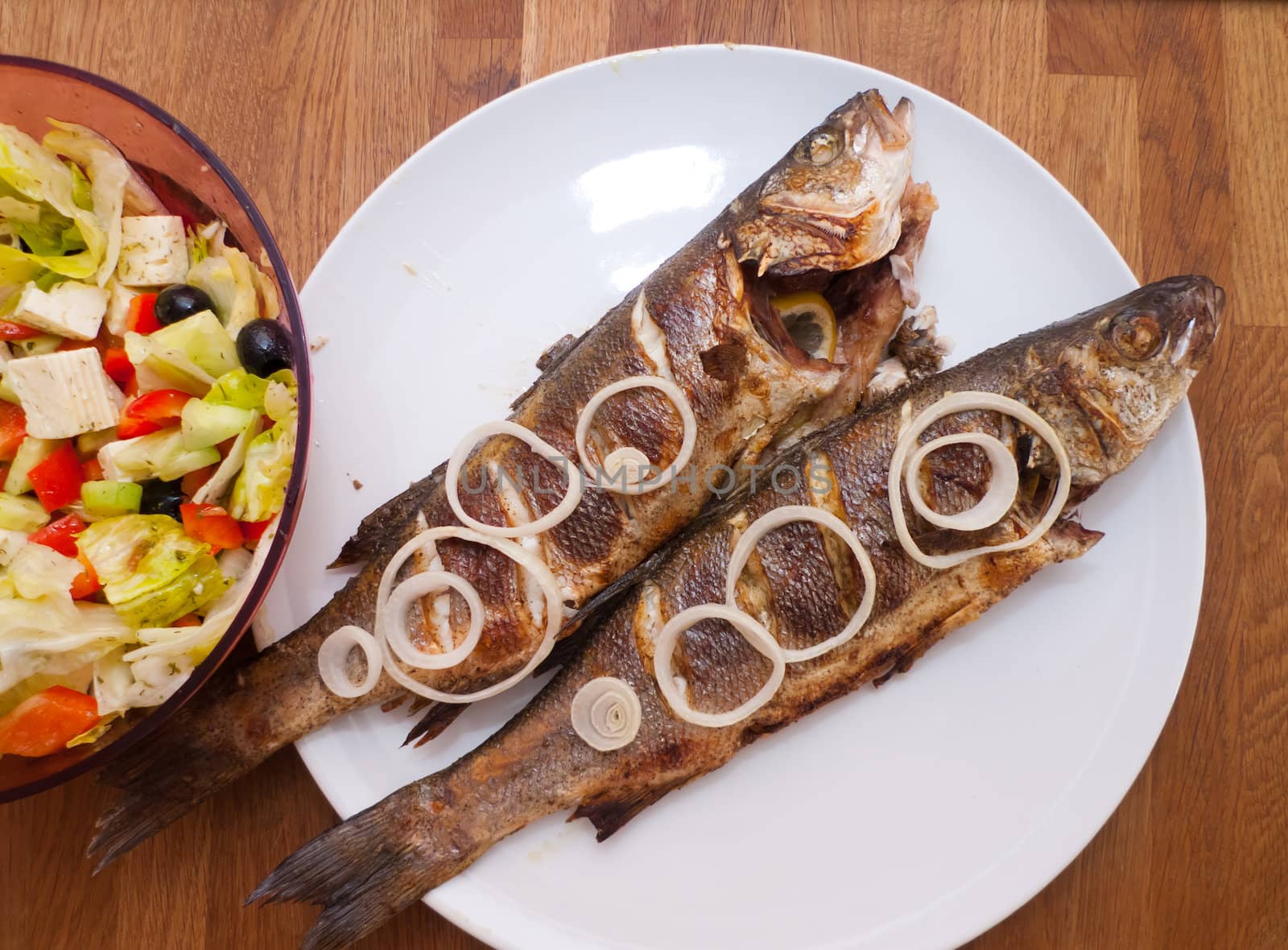 Photo of two grilled fishes ready to eating
