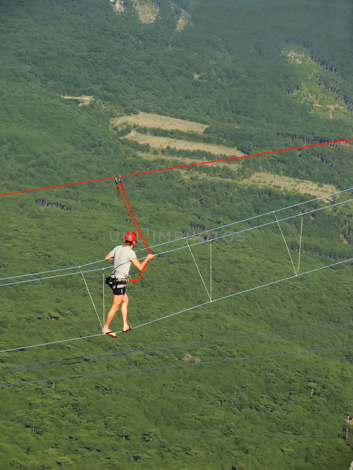 Man walking on a rope at Ai-Petri summit, Crimea peninsula, Ukraine