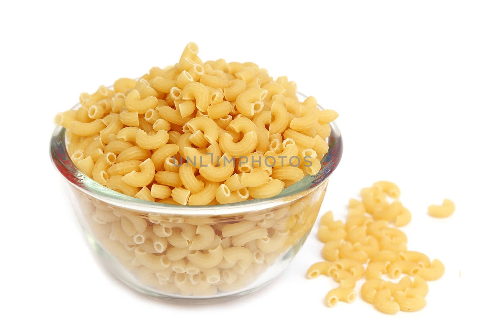 Macaroni in a glass bowl on white background 