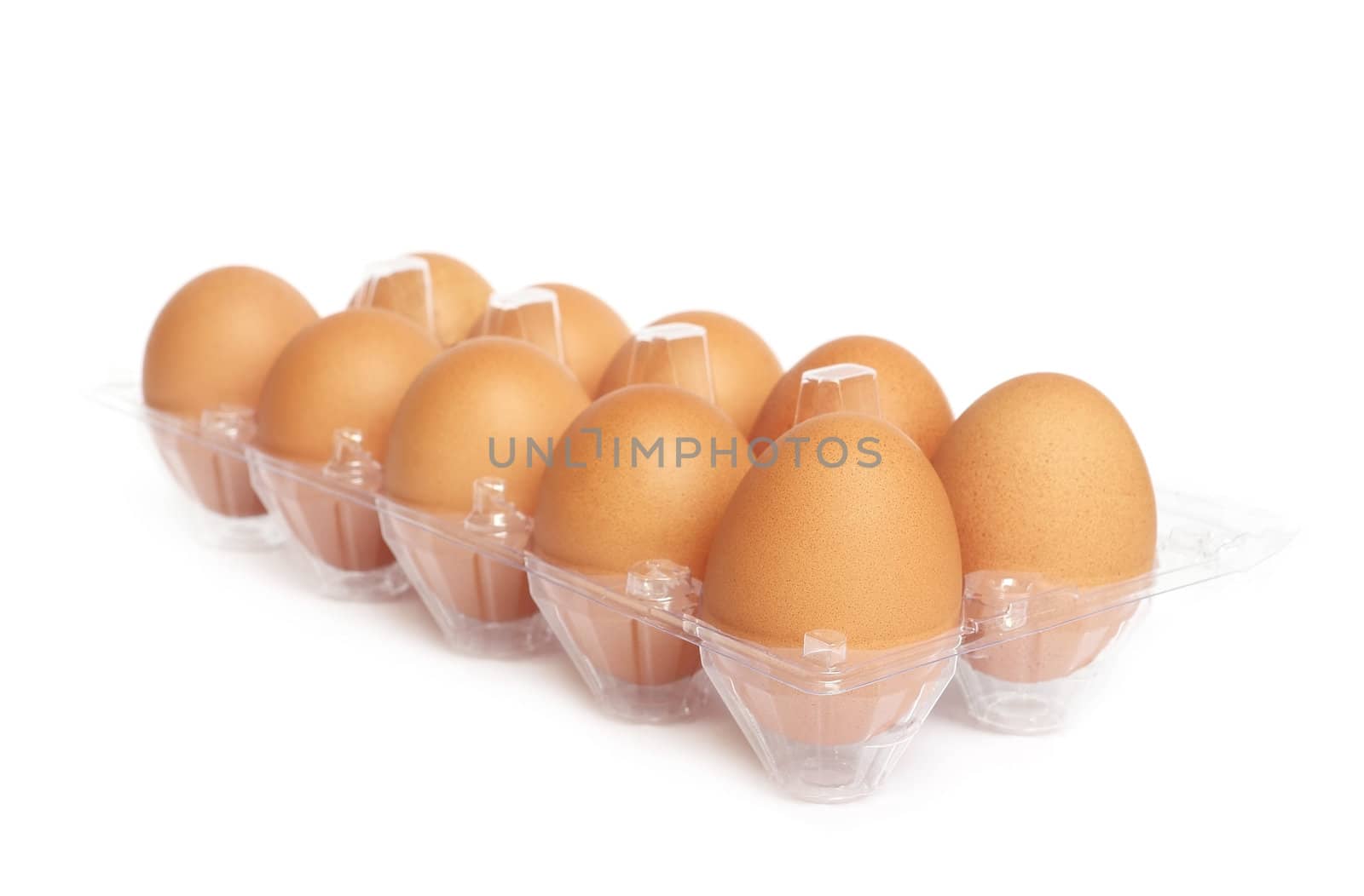 Eggs in the plastic package on white background