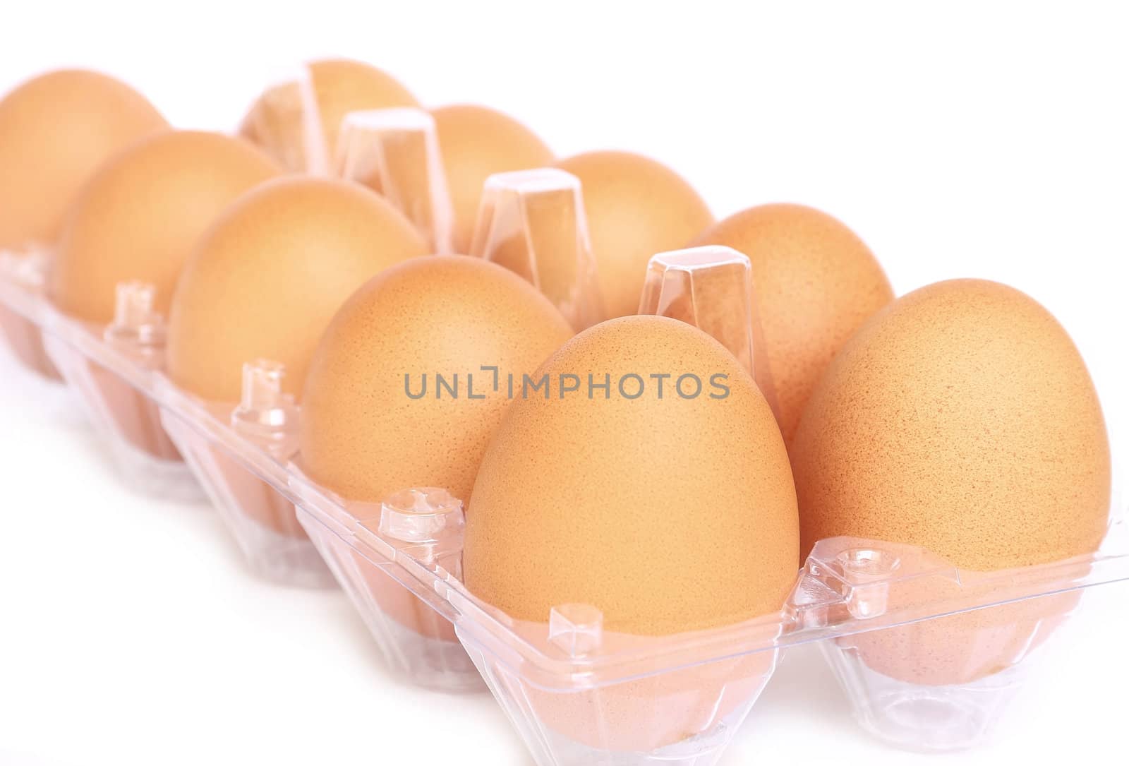 Eggs in the plastic package on white background